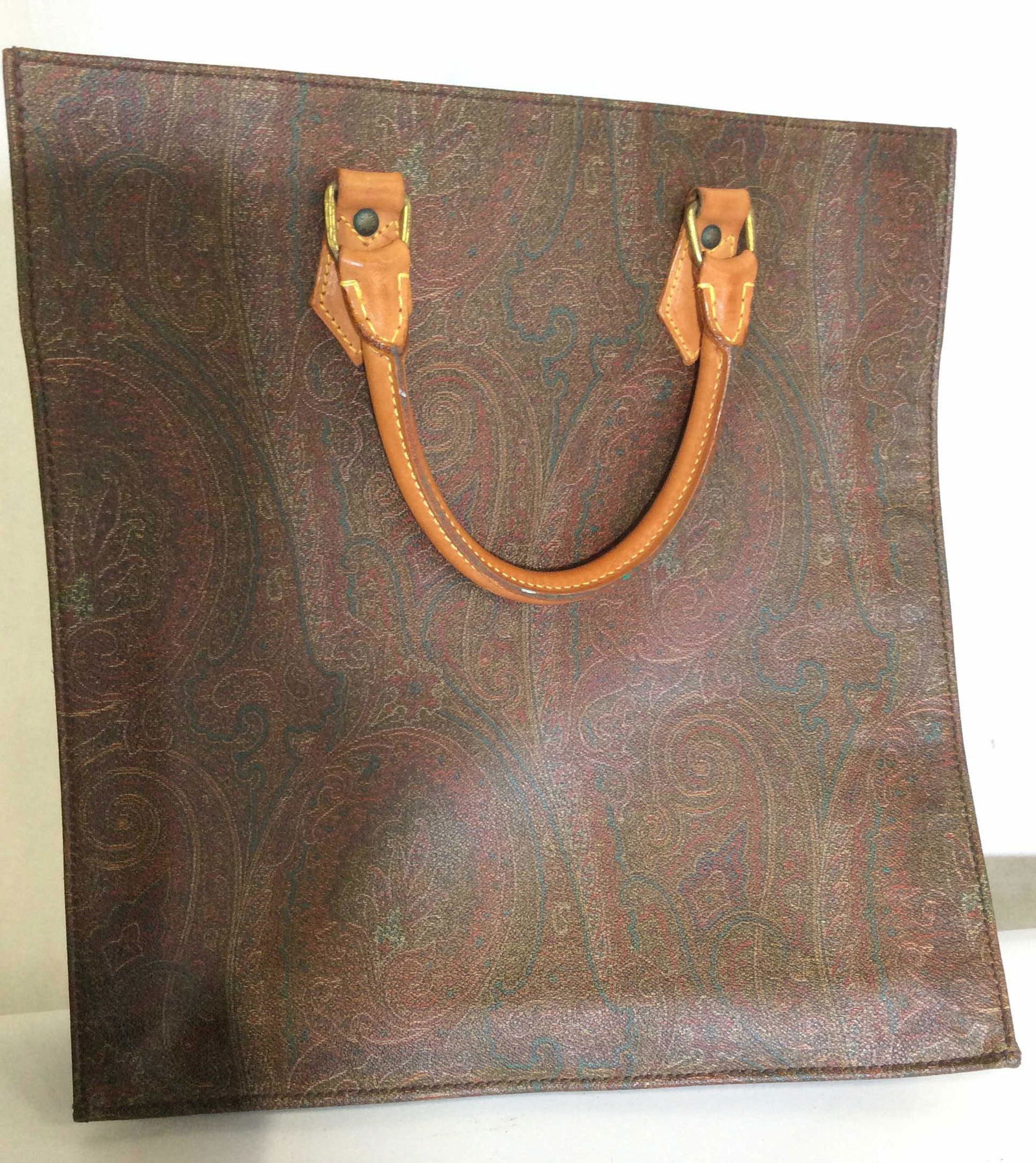 Signed ETRO Large Paisley Tote Bag, Milan Italy: Leather covered cord handles, 4.5 in drop. Large, Muted paisley design, soft blonde leather interior, 15 in long, 14 in wide, 3 in depth. Sewn leather label reads ETRO Maker in Milano, Italy. Outer: C