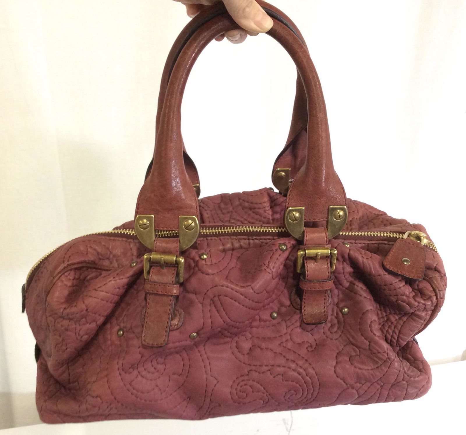 Signed Vintage ETRO Stitch Design Leather Handbag: Made in Italy, Maroon Color Handbag, calf Leather with black stitching creating a paisley design. Gold tone hardware , leather covered handles , drop app 6 in. Interior Signed ETRO Lining, mustard col