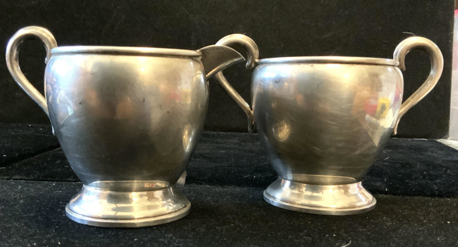 Empire Sterling Silver Creamer Sugar Set: Marked underside for Empire Weighted Sterling number 27, short ringed pedestal base, pot bellied trophy style shaping, curved handles, taller measures ht 4 inches width 5 inches, total weight for both