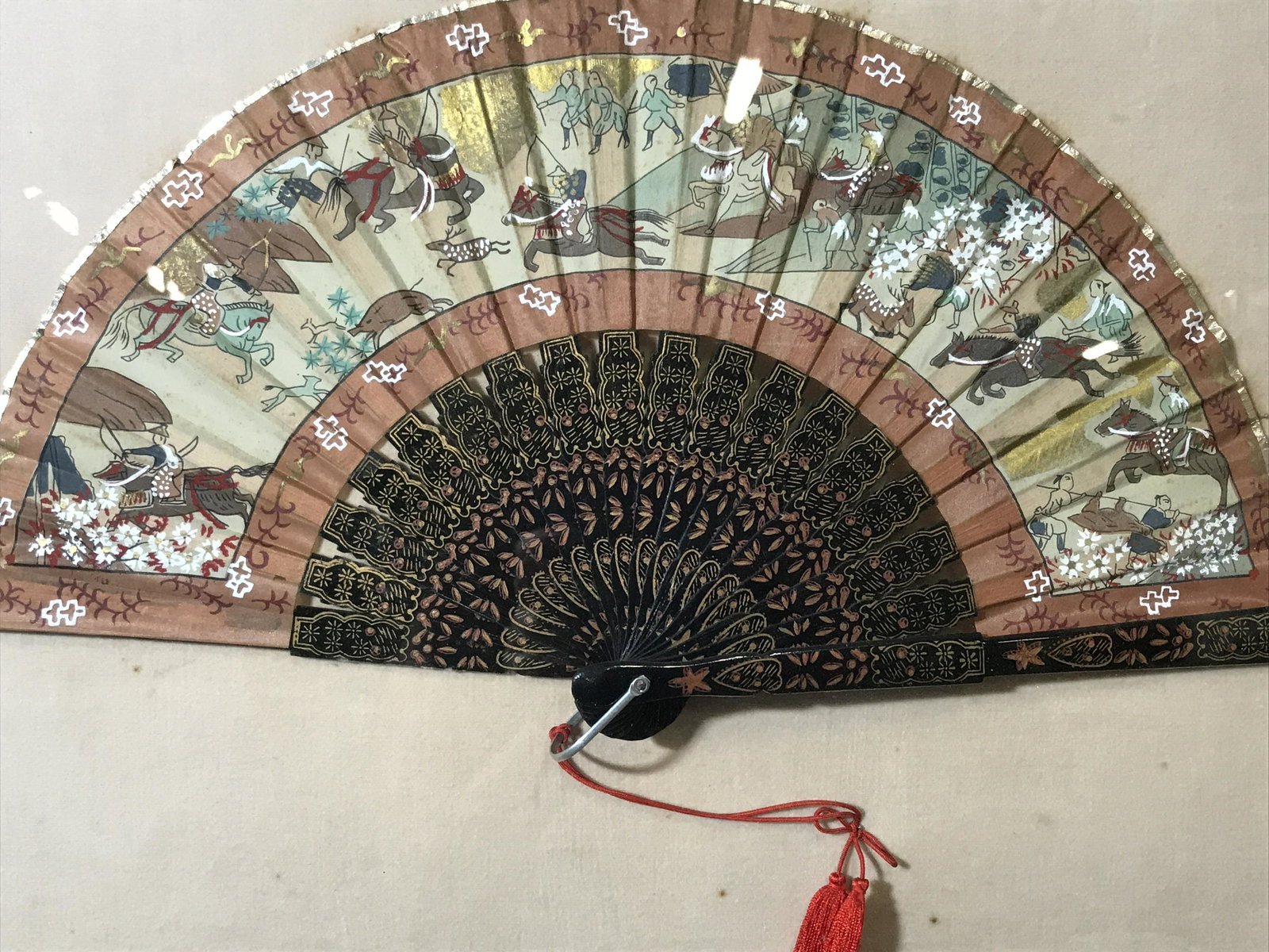 Shadow Box Framed Asian Painted Ladies Hand Fan: Shadow box framed Asian painted fan, Asian style possibly Japanese, fan displays a scene of a battle field landscape covered in Calvary and swordsmen, silver foil lining to the edges of the fan, matte