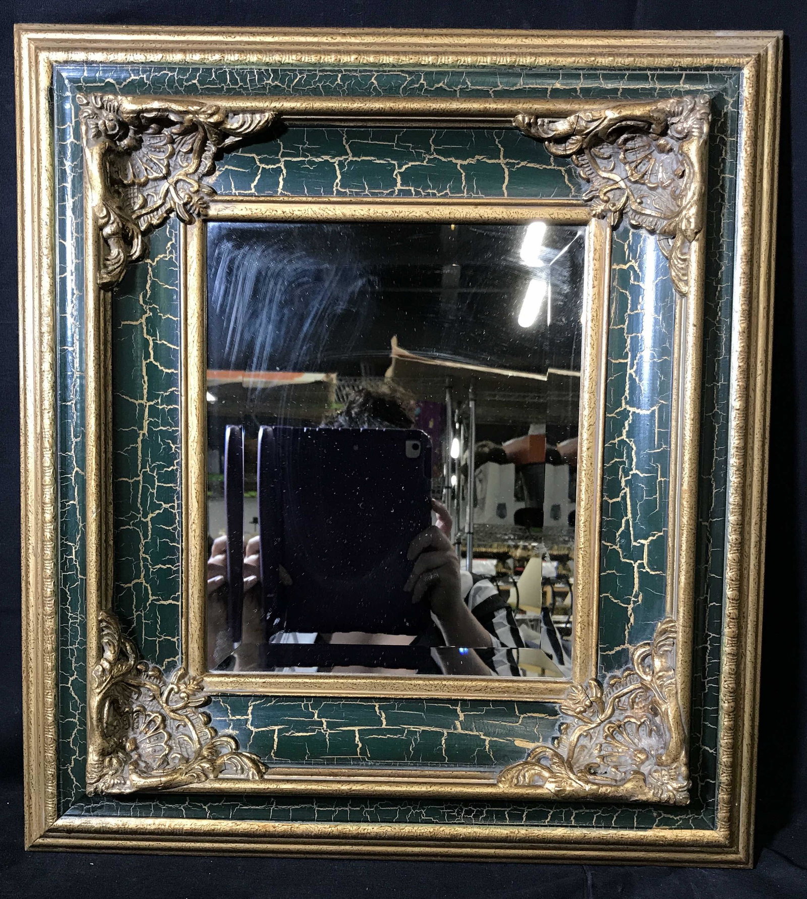 Gilt Wood & Green Craquelure Mirror: Gilt wood and green Craquelure mirror, hand carved heavily ornate Wood mirror frame in gilt wood, a layer of green craquelure has been applied to the divots of the frame, some smudges to mirror can be