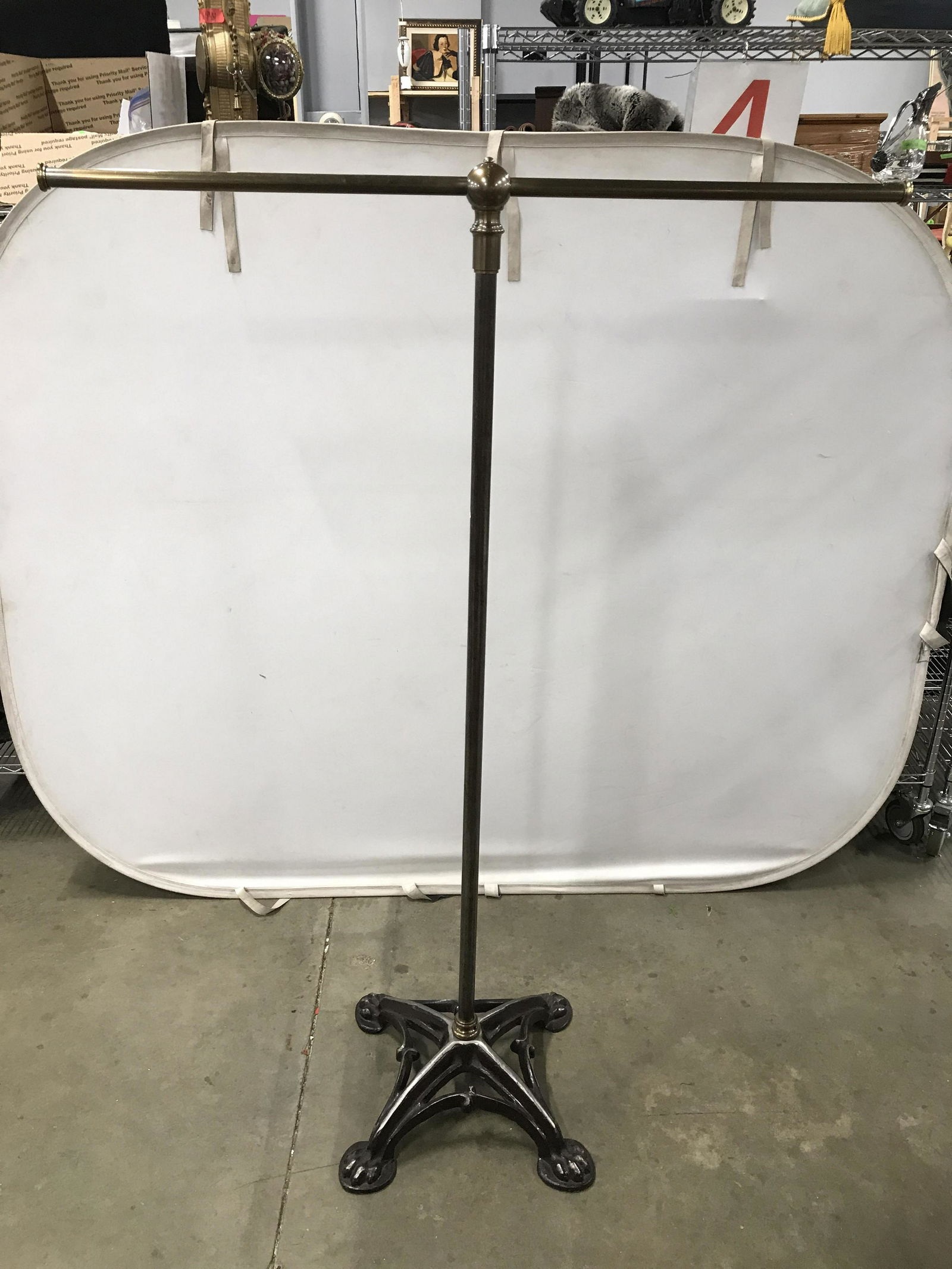 Tall Antique Iron & Brass 2 Arm Coat Stand: Coat stand is brass & iron. Piece has paw style feet. Piece has tones of gold, silver, & bronze. Piece measures approximately 69 inches tall 48 inches long 20 inches deep. Coat rack, antique coat rack