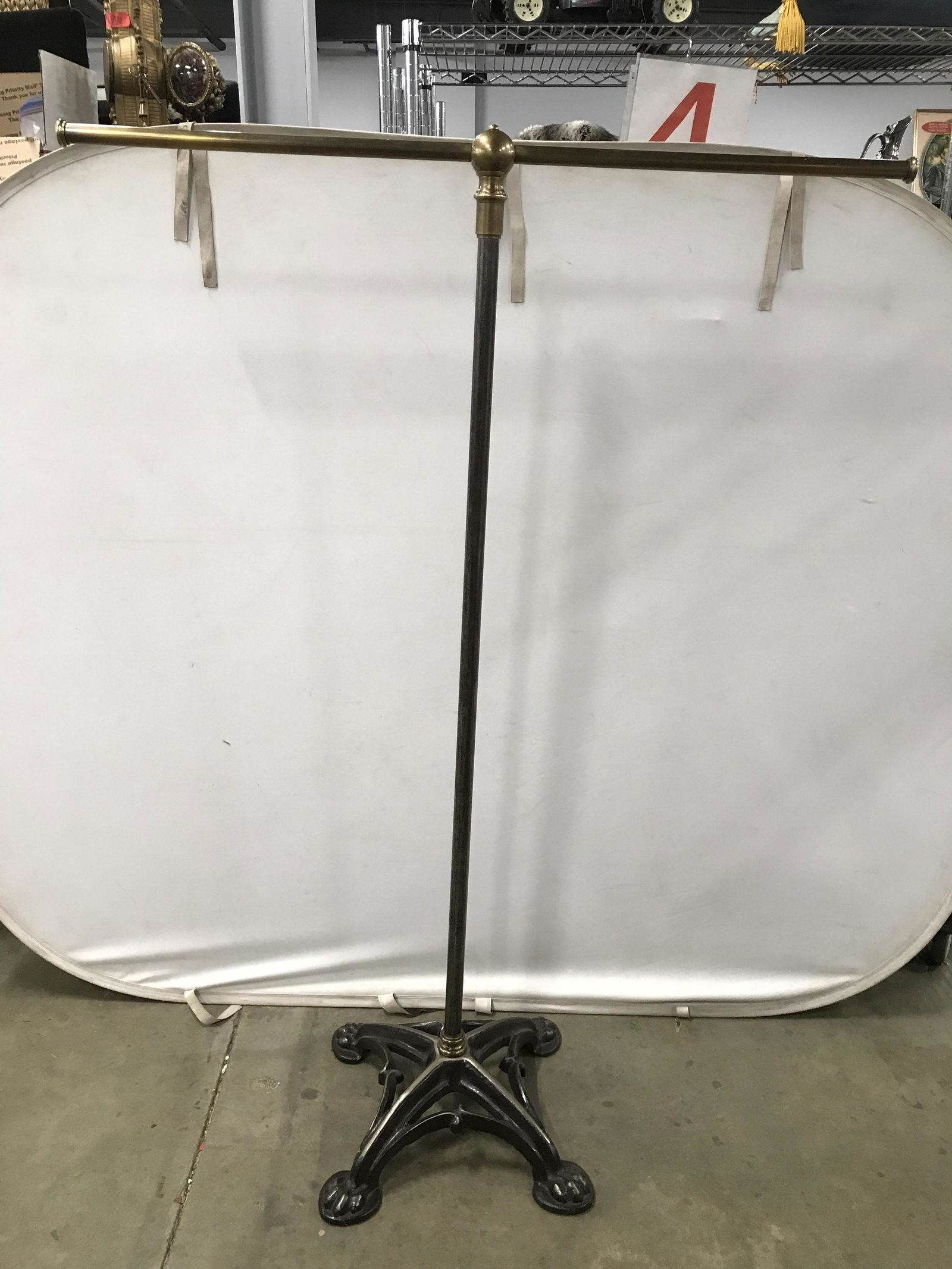 Tall Antique Iron & Brass 2 Arm Coat Stand: Coat stand is brass & iron. Piece has paw style feet. Piece has tones of gold, silver, & bronze. Piece measures approximately 69 inches tall 48 inches long 20 inches deep. Coat rack, antique coat rack