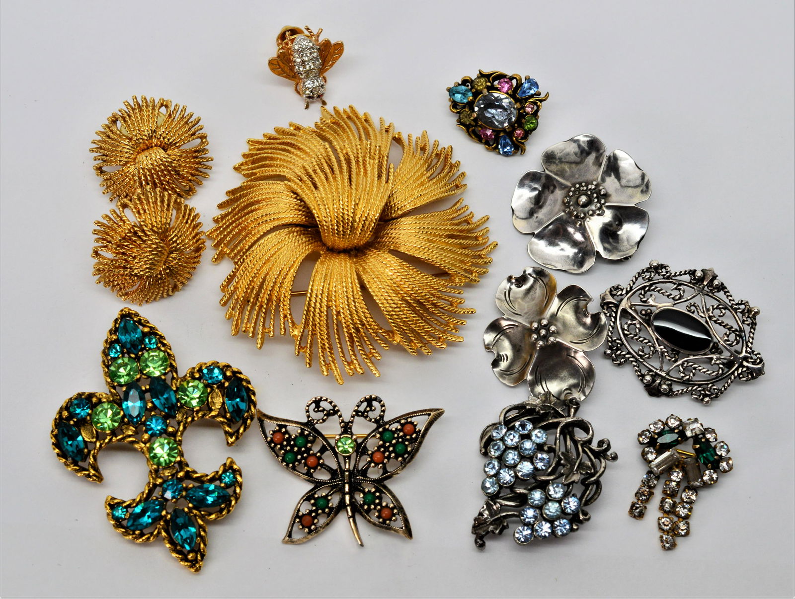 Lot of Ten Vintage Pins - Monet, Stuart Nye, more: Fabulous Monet goldtone starburst pin w matching earrings. Lovely sterling silver duo of Dogwood Blooms by designer Stuart Nye. Whimiscal Bee pin w ruby & CZ's. Vintage Hollycraft ,circa 1950, w pink,