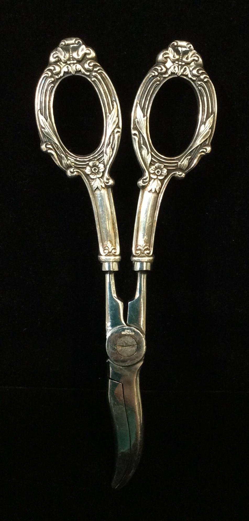 Art Nouveau Scissor Candle Wick Trimmer: Wick Trimmer with embossed art Nouveau Design. Sterling silver fingered handles. Stainless steel clippers. Marked Sterling at end of Handle right before clippers. Fleur De lis, flowers and laurel desi