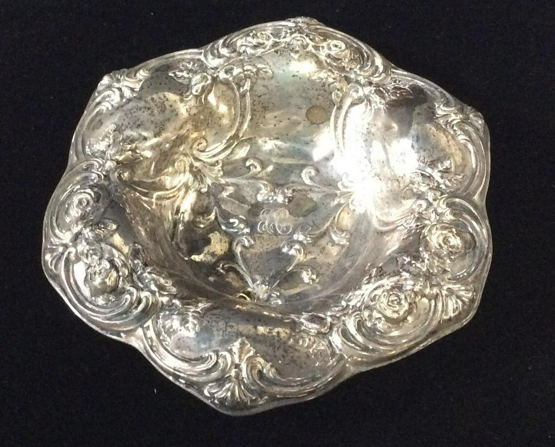 Baroque Repoussé Sterling Shallow Bowl: Heavily Detailed Bowl w/ Fleur De lis & Scroll patterns. Marked with Lion, Anchor and Letter B passant , reads STERLING A55628. Possibly antique. App 6 in diameter. Monogrammed on inner bowl. 2.12 ozt