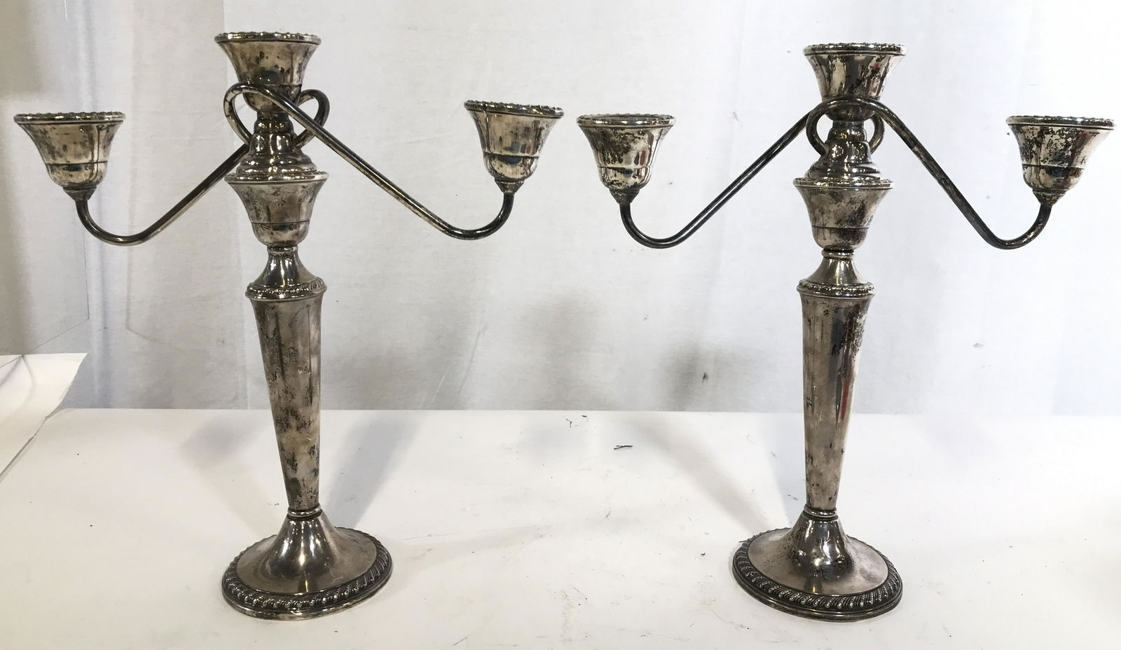 Pair RODGERS Sterling Weighted Candelabras: Underside of pieces are marked RODGERS STERLING WEIGHTED. Pieces measure approximately 9 inches tall 11 inches wide. Pieces weigh approximately 25.93 Troy ounces. Sterling silver candelabras, sterling