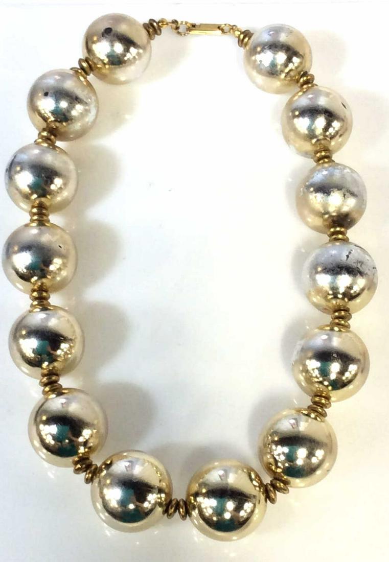 Signed DAUPLAISE VNTG Statement Bead Choker: App 12 in. NYC Jewelry Designer Carol Dauplaise. Silver toned beads app 1 in rounds, separated by gold tone flat disc beads. Clasp reads DAUPLAISE & Patent 3427691. Vintage Wear constant with exposure