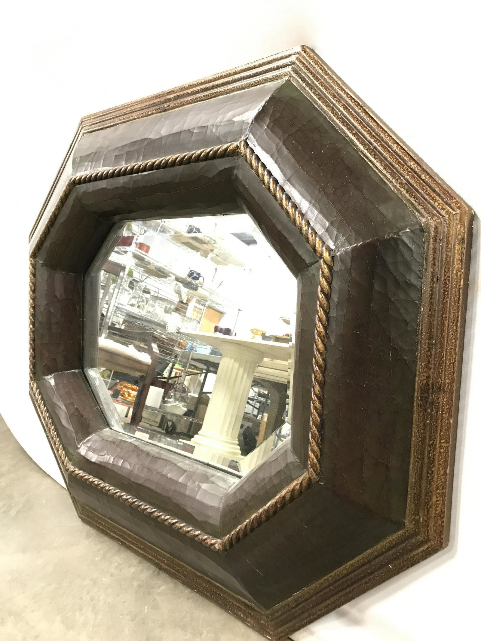 Beveled Octagon Mirror: Mirrored surface is beveled. Frame has elongated octagonal shape. Frame also has rope twist detail. Mirror can hand vertically or horizontally. Piece measures approximately 37 inches long 33 inches ta