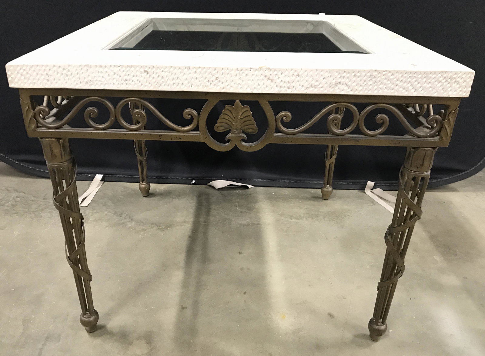 PTMC Iron Victorian Garden Style Side Table: Underside has tag which reads PTMC. Side table has wood, composite and class top. Table base appears to be iron. Piece has S curve detail directly below tabletop. Piece has 4 metal legs with wrapped r