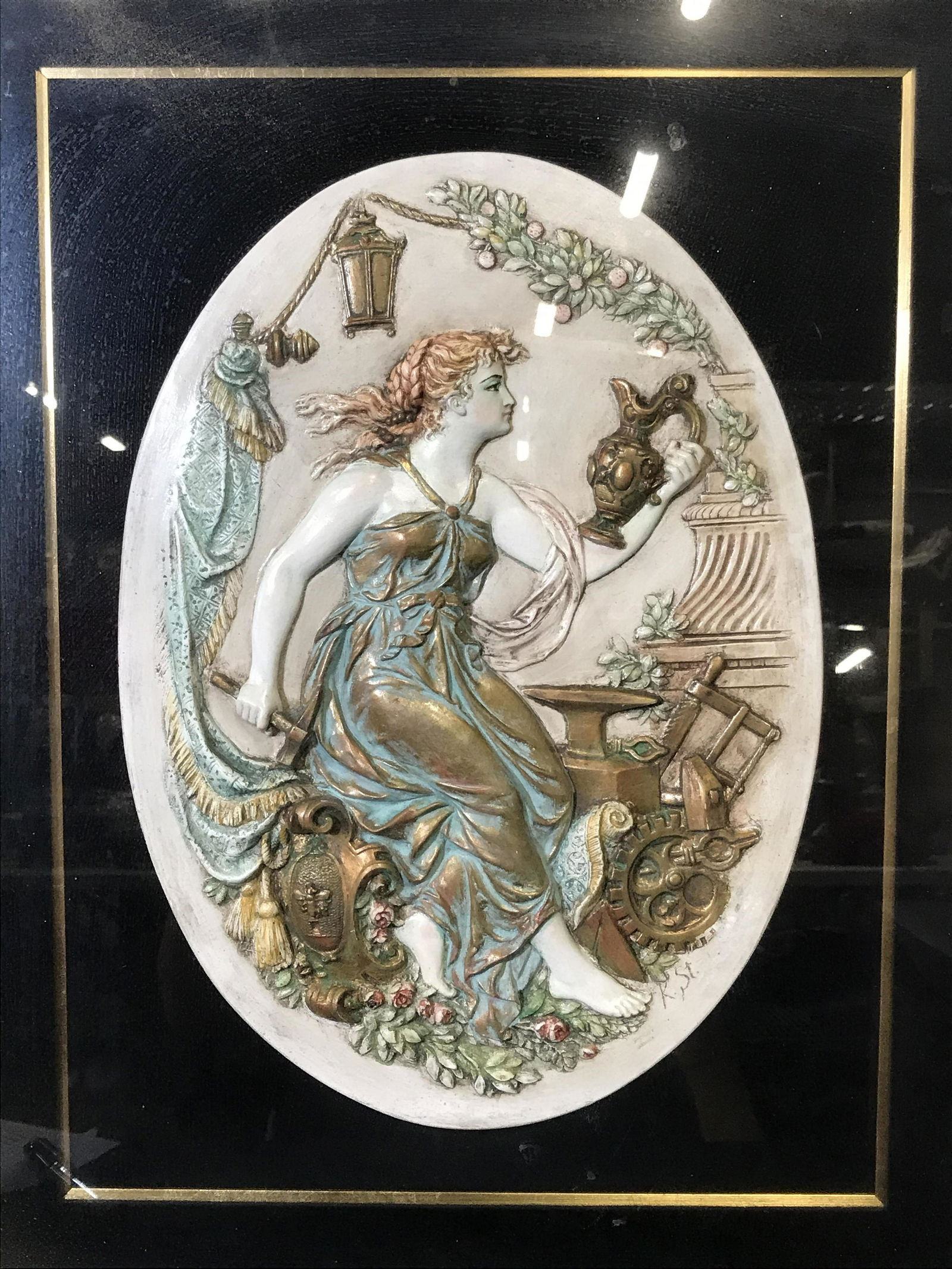 Signed Greek Mythological Porcelain Relief: Signed framed Greek mythological Porcelain relief, initials in the lower right section read ‘K.St.’, subject a female figure in golden robes holding a pitcher and hammer while standing above and a