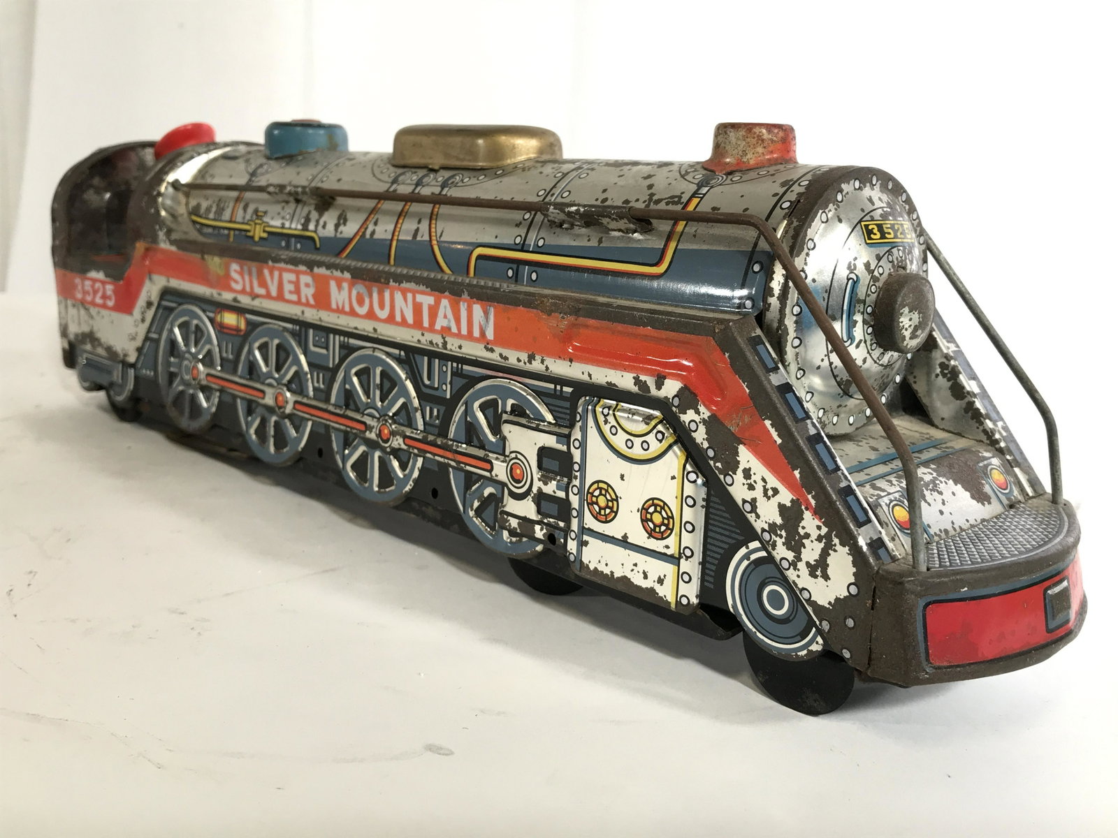 Vintage MODERN TOYS Metal Toy Train: Piece reads MODERN TOYS on backside. Toy train is vintage possibly antique. Piece is metal. Contains conductor Figural at back of piece. Train, toy train, vintage toy train, model train, silver mounta