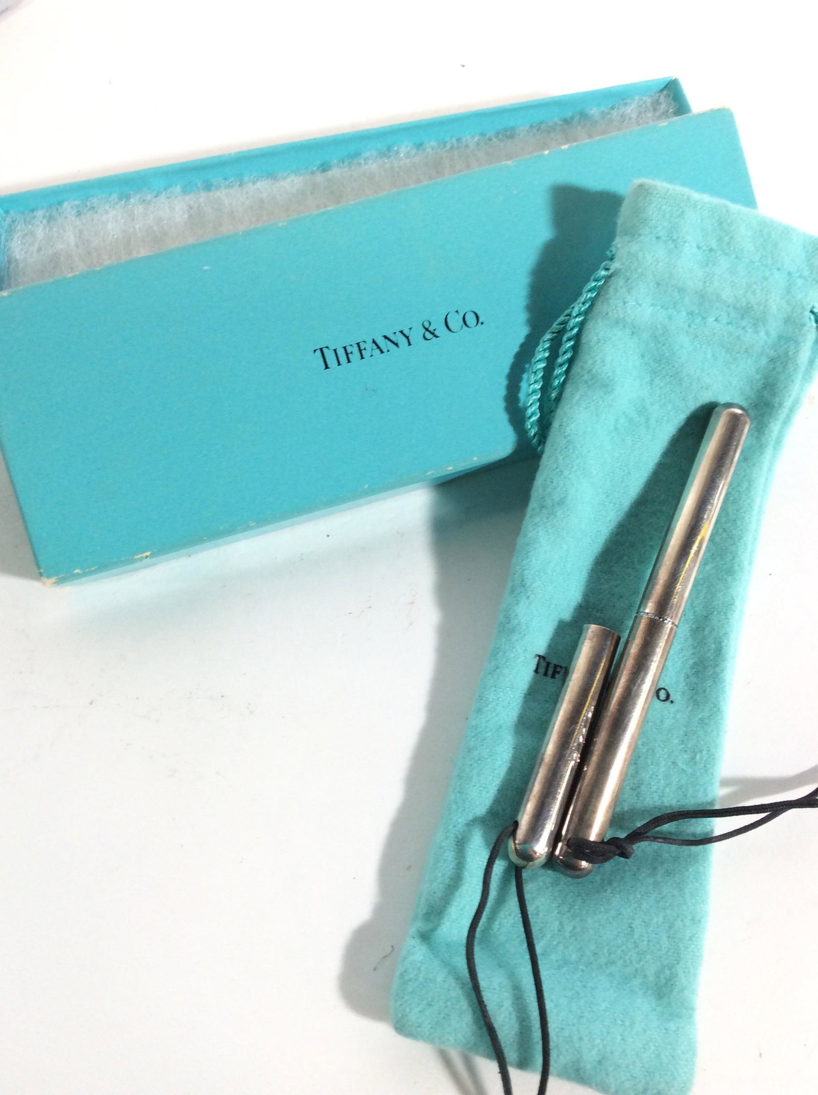 TIFFANY Ball Point Pen in Tiffany Box & Cover: Rope Necklace with attached pen, Cord length 34 in. Can replace pen ink insert. .45 ozt, without pen insert, Push and turn to snap on cover. Pen 3.5 in long, additional piece on rope, incomplete pen. 
