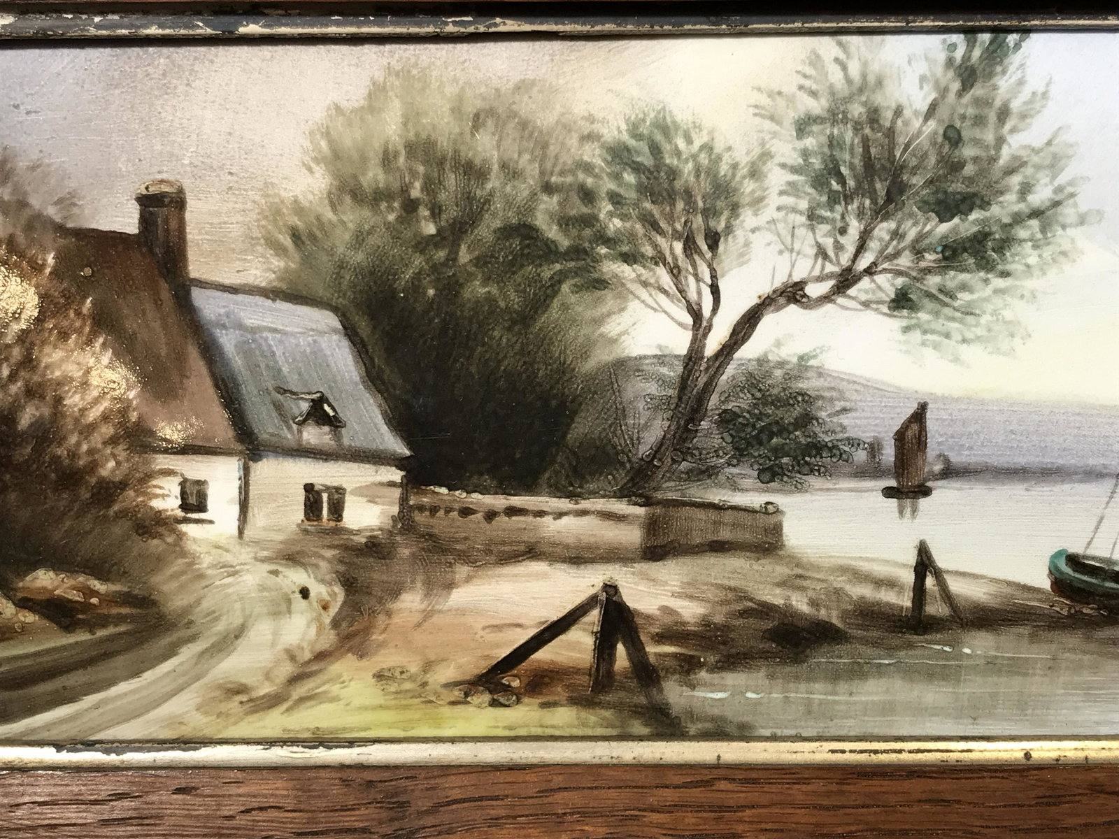 Pair of Framed Hand Painted Tiles, Landscapes: Pair of Hand painted tiles, no apparent signature, text on the reverse of both illegibly written, subject of one a summer scene of a house and boat by a river, subject of second one a winter scene of 