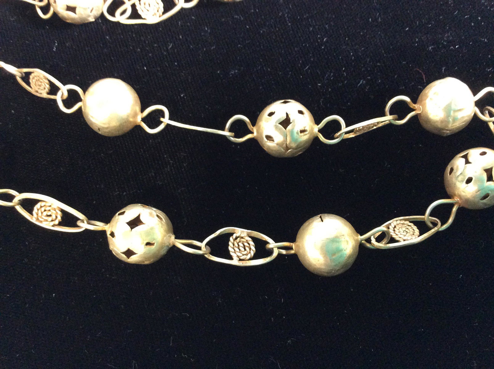 Vintage Middle Eastern Brass Beaded Necklace: Hand crafted Necklace. 80 in. Hangs app 40 in.. 12-13 mm brass orbs, alternating with pierced design and solid metal. Chain links resemble evil eye Amulet , shape of eye with rounded wire as eyeball. 