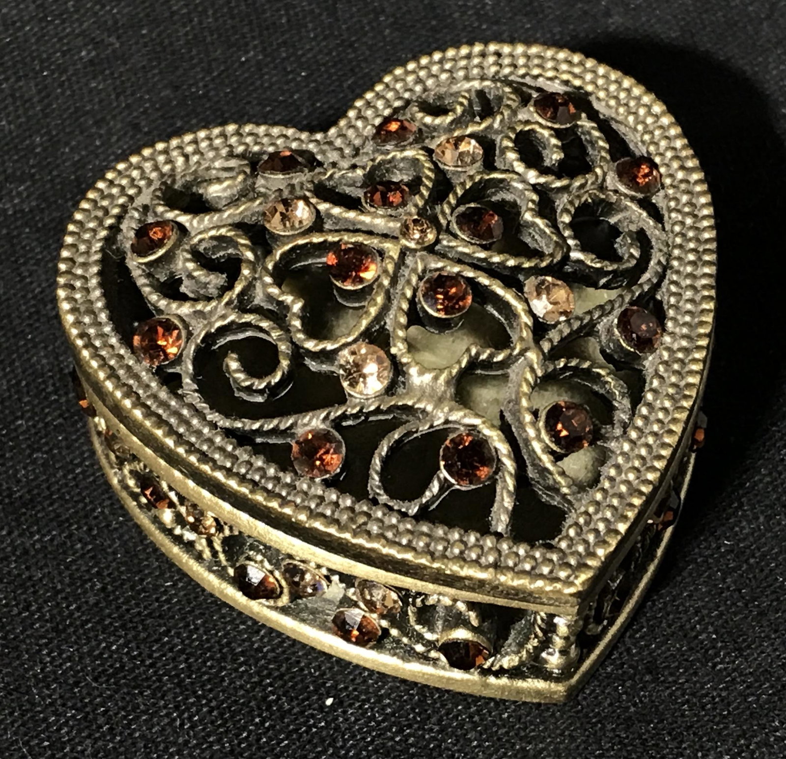 Rhinestone Detailed Metal Heart Trinket Box: Bedazzled Metal heart trinket box, bedazzled with caramel and brown rhinestones, made of a brass colored metal, interior has a resin floor, measures 1.75 inches at widest, Bedazzled box, metal box, tr