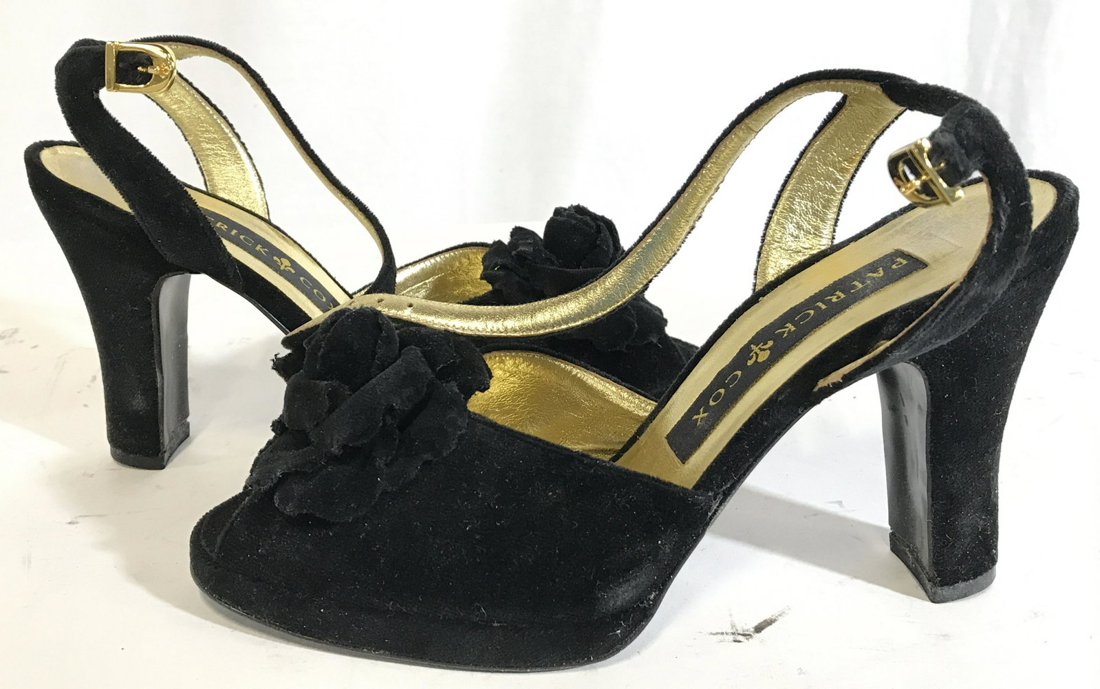 PATRICK COX Women’s Heels Size 37: Label on sole reads PATRICK COX. Shoes are black toned with gold toned sole. Heel is 4 inches high. Front of shoe has floral shoe ornament. Women’s shoes, women’s heels, Patrick cox shoes, Patrick