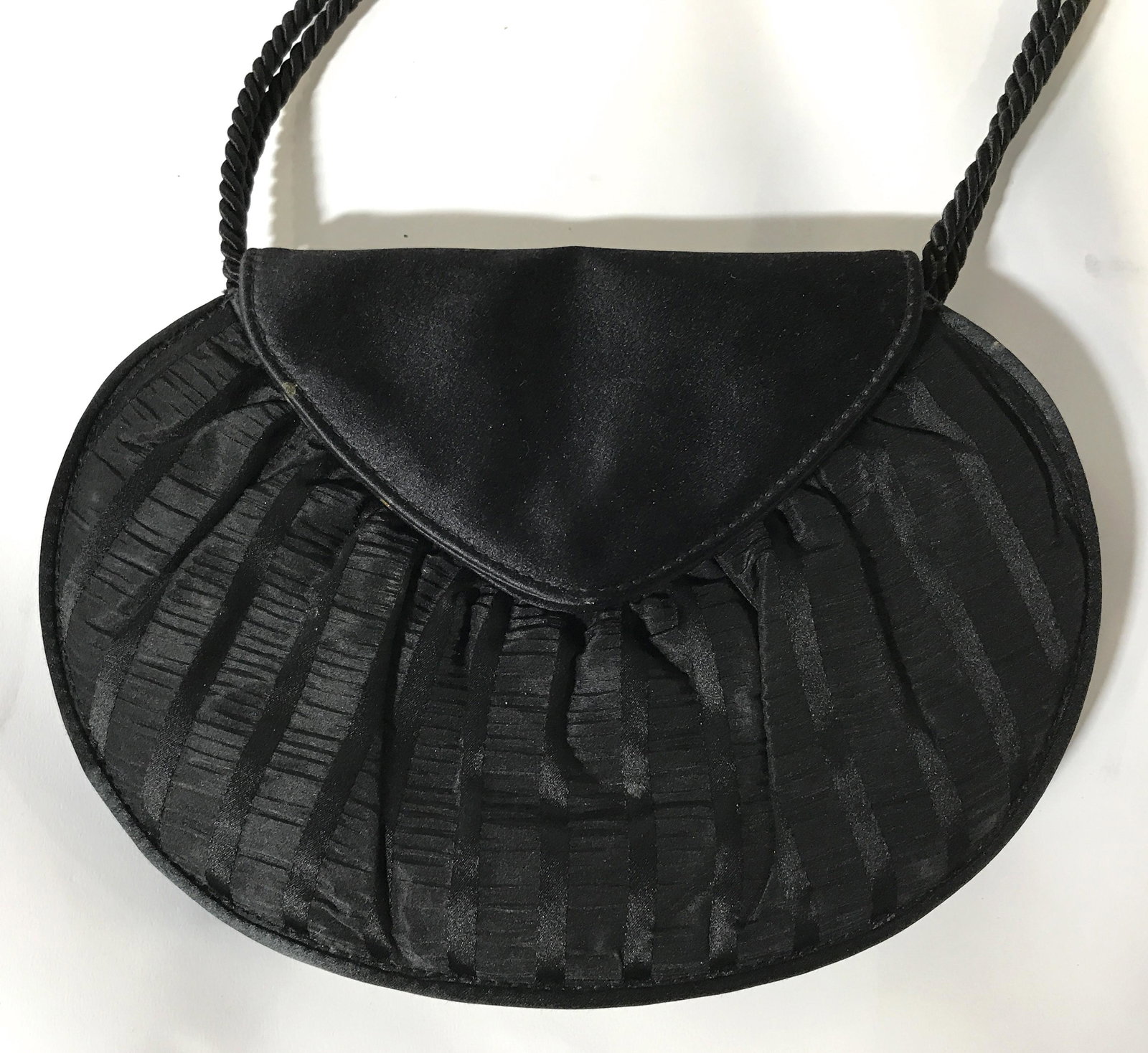O’Dea Italian Black Purse: O’Dea Italian black purse, purse has a ruffled design with striped and some gold metal toned parts, made of a black silky possibly polyester material, includes a long strap made of a braided chord,