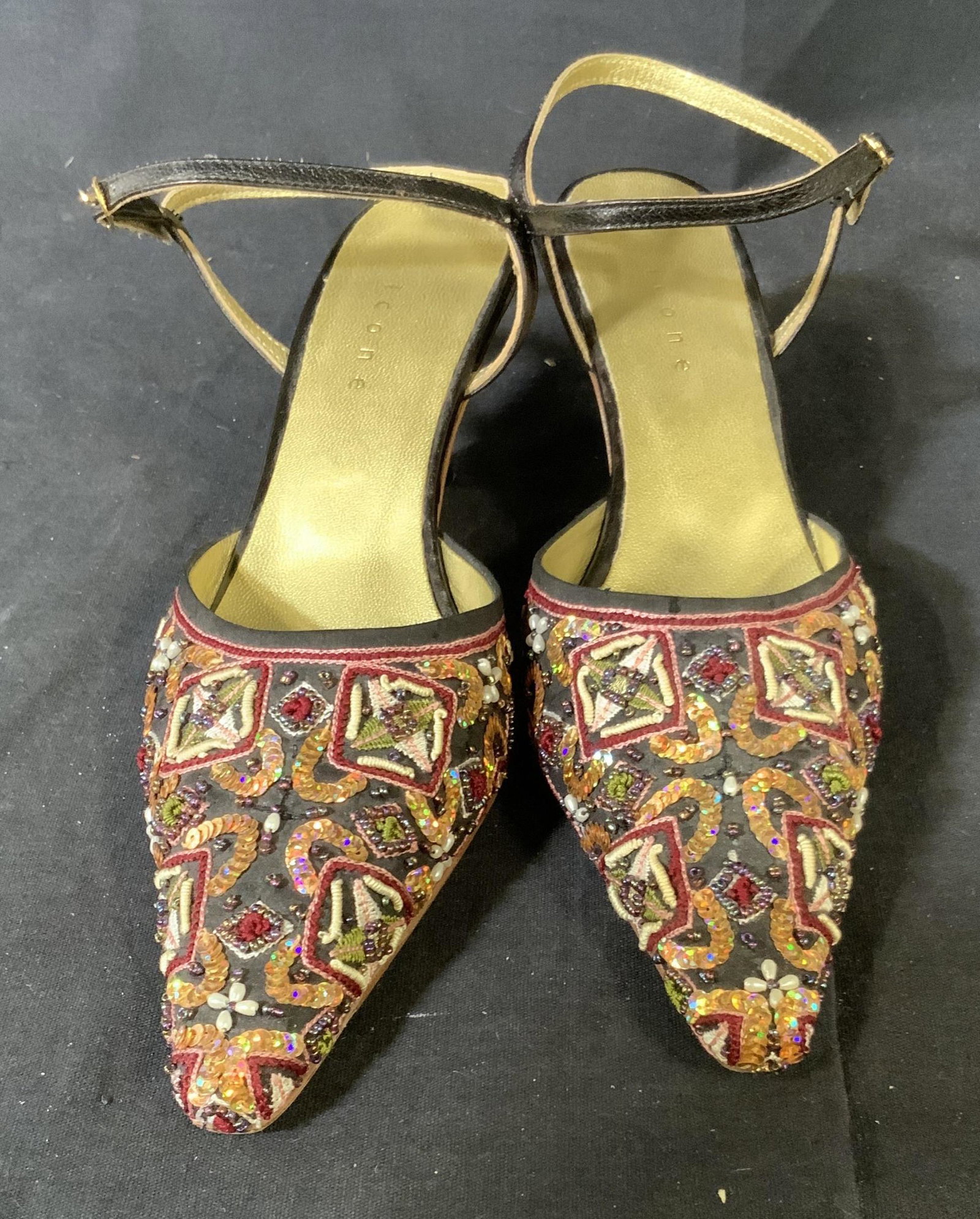 Vintage Icone Brand Heels: Embossed ICONE, vintage, pointed toe shoe with a black leather strap around the ankle, pointed toe, there is a mix of detailed beading appliqué and embroidery, size 36.5 in European sizes, 2.5 inch t