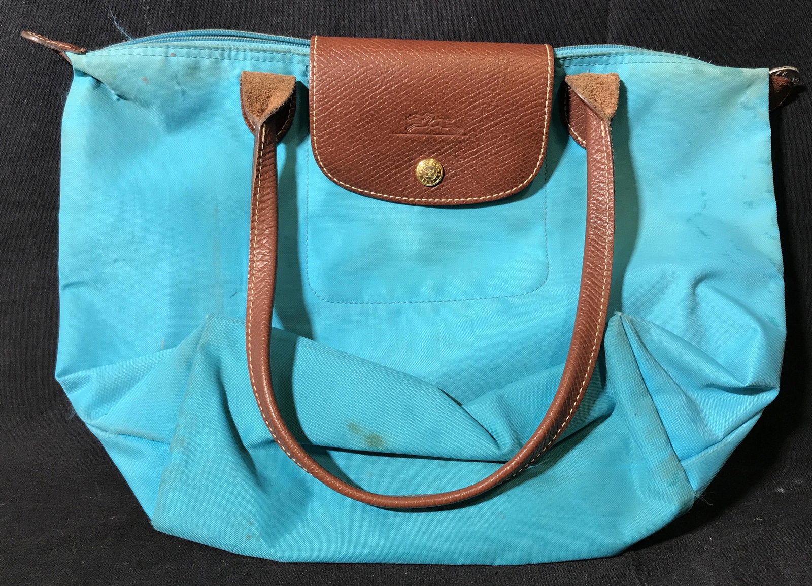 Longchamp Codura Blue Bag: Longchamp Codura Blue bag, made of a blue water proof material With brown leather accents, includes a two brown leather straps to either side, no lining to bag, bag measures approximately 15 inches lo