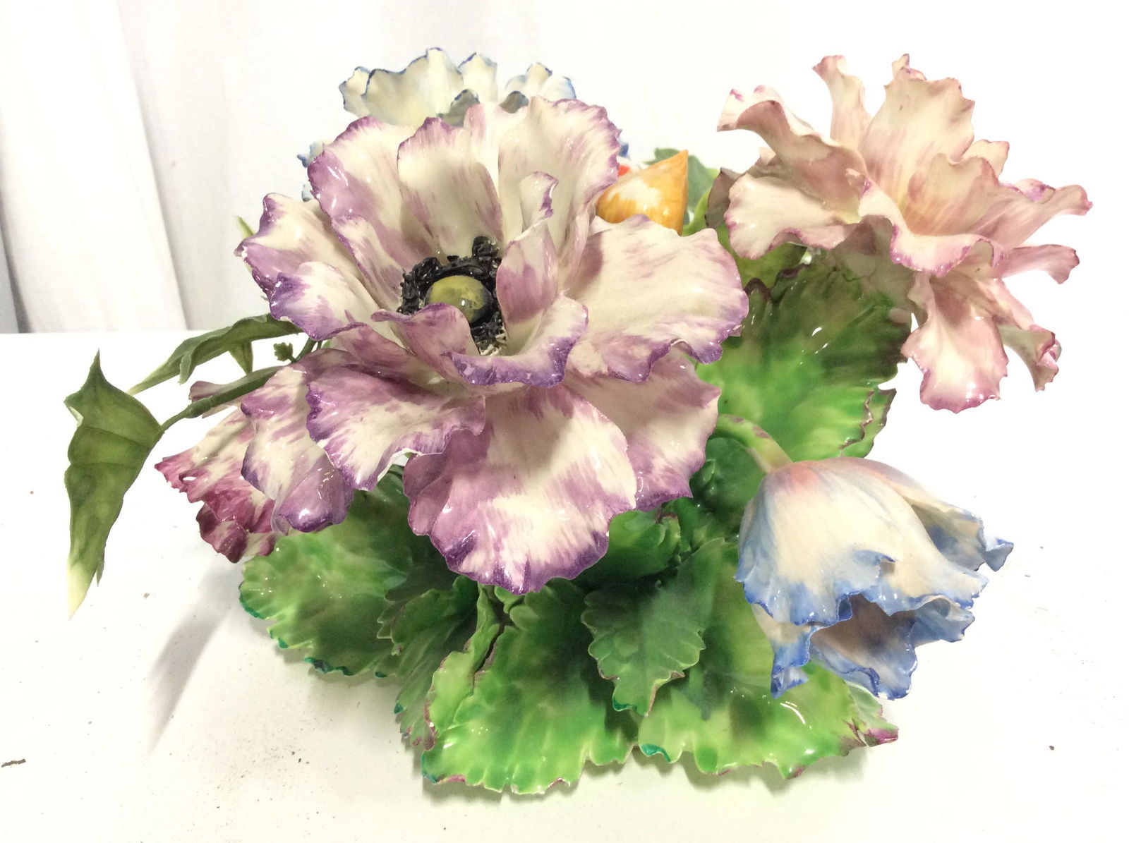 Capodimonte Style Porcelain Floral Arrangement: Piece appears to be vintage. Porcelain flowers and leafs appear to possibly be hand painted. Piece Has porcelain leaves and other synthetic leaves. Piece measures approx 14 inches wide 7 inches tall.