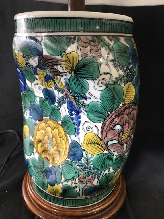Pair Japanese Porcelain Geisha Pillow Lamps: Green, blue & yellow florals on white porcelain. Carved wood stand, traditional style silk shades. Porcelain in shape of a Japanese pillow, or headrest. Base 6.5 in. diameter, total ht, 22 in. Shade a