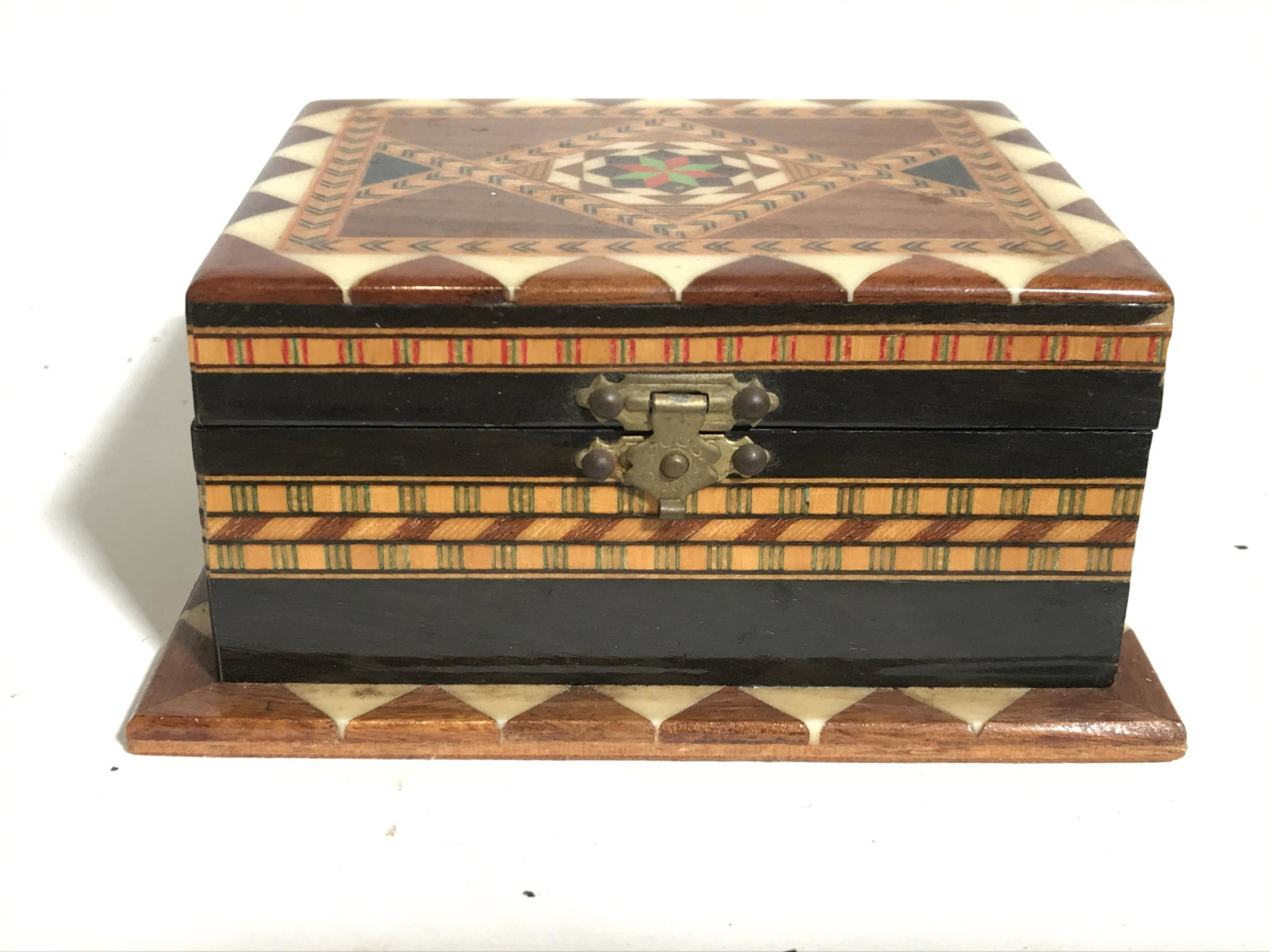 Vintage Tribal Style Keepsake Box: Trinket box is vintage. Piece has intricately detailed tribal style. Piece appears to possibly have inlaid wood and carved bone detail. Piece also has geometric detail. Piece measures approximately 4.