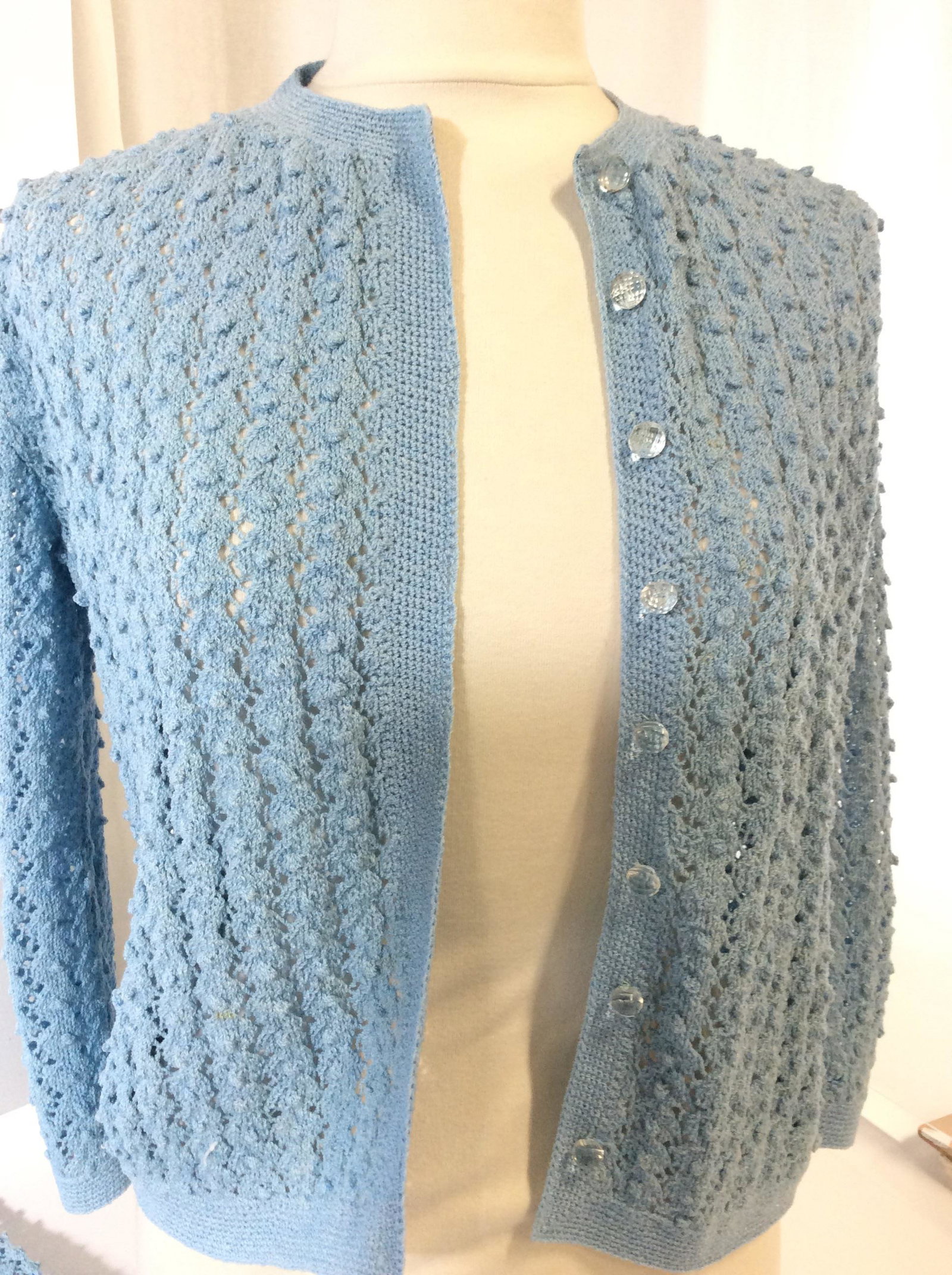 Vntg Hand Crochet Skirt - Cardigan Ensemble: Sky blue outfit, crochet by hand, Pierced pattern, size Small. Skirt waist app. 24 in., length 25 in. Cardigan has clear faceted Ball buttons. Couple light spots on sweater. Possibly cotton/ acrylic/e