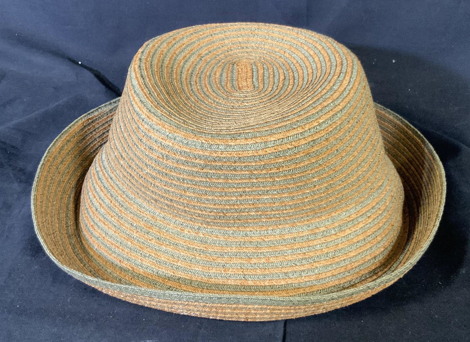 Eric Javits Brand Convertible Bucket Hat: label reads Eric Javits New York, Brand Convertible Bucket Hat, in horizontal orange and grey in the inside crown of the hat are directions for packing and storing, additionally tag is still attached 