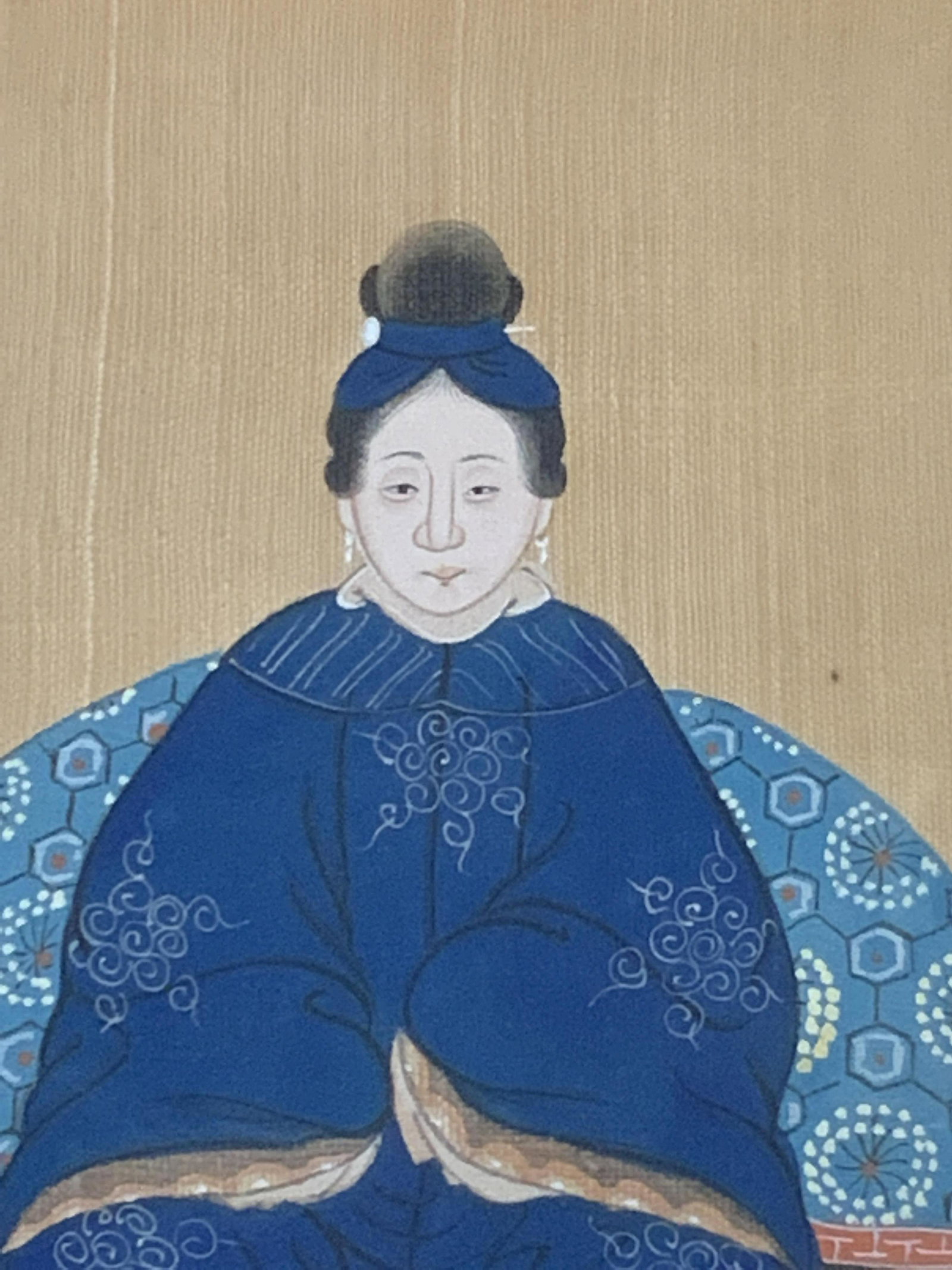 Asian Art Portrait of a Woman: Pan-Asian Portrait of a women in traditional garb, likely hand painted onto its light brown fabric background, ornate detail in the garb, matted on a light tan with a minimalist wooden frame painted g