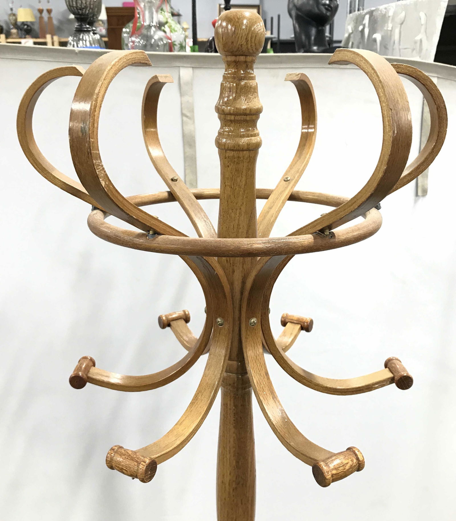 Vintage Carved Wooden Coat Stand: Coat stand is wooden. Piece appears to be vintage. Rack contains 6 coat hooks. Piece is possibly bentwood. Piece has curved tripod style legs. Piece measures approximately 72 inches tall 15 inches wid