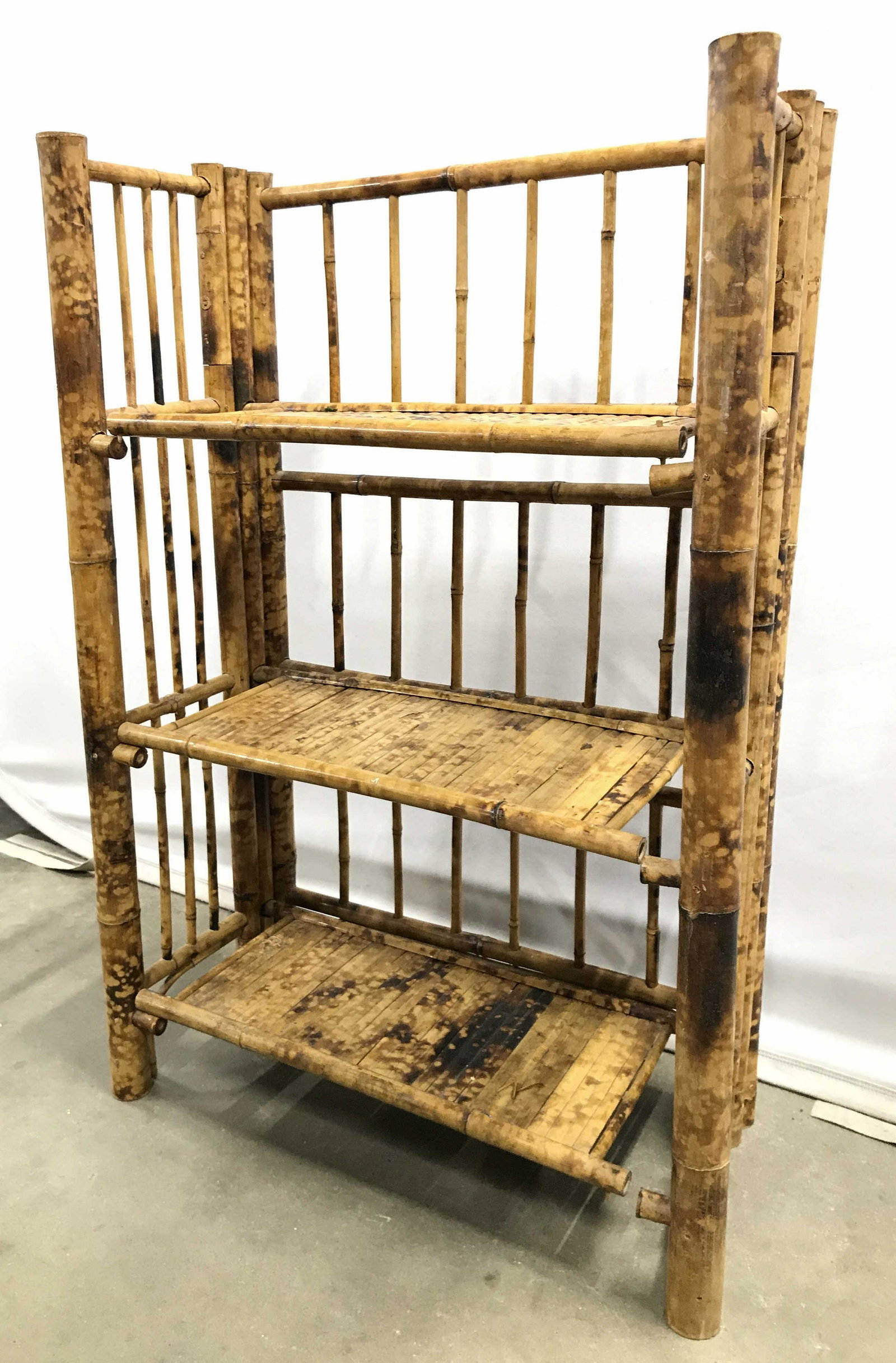 3 Tier Bamboo Style Display Shelf: Display shelf has bamboo style, possibly genuine bamboo. Piece appears to be vintage. Piece has 3 shelves. Display shelf has tones of tan and brown. Piece measures approximately 32 inches tall 20 inch