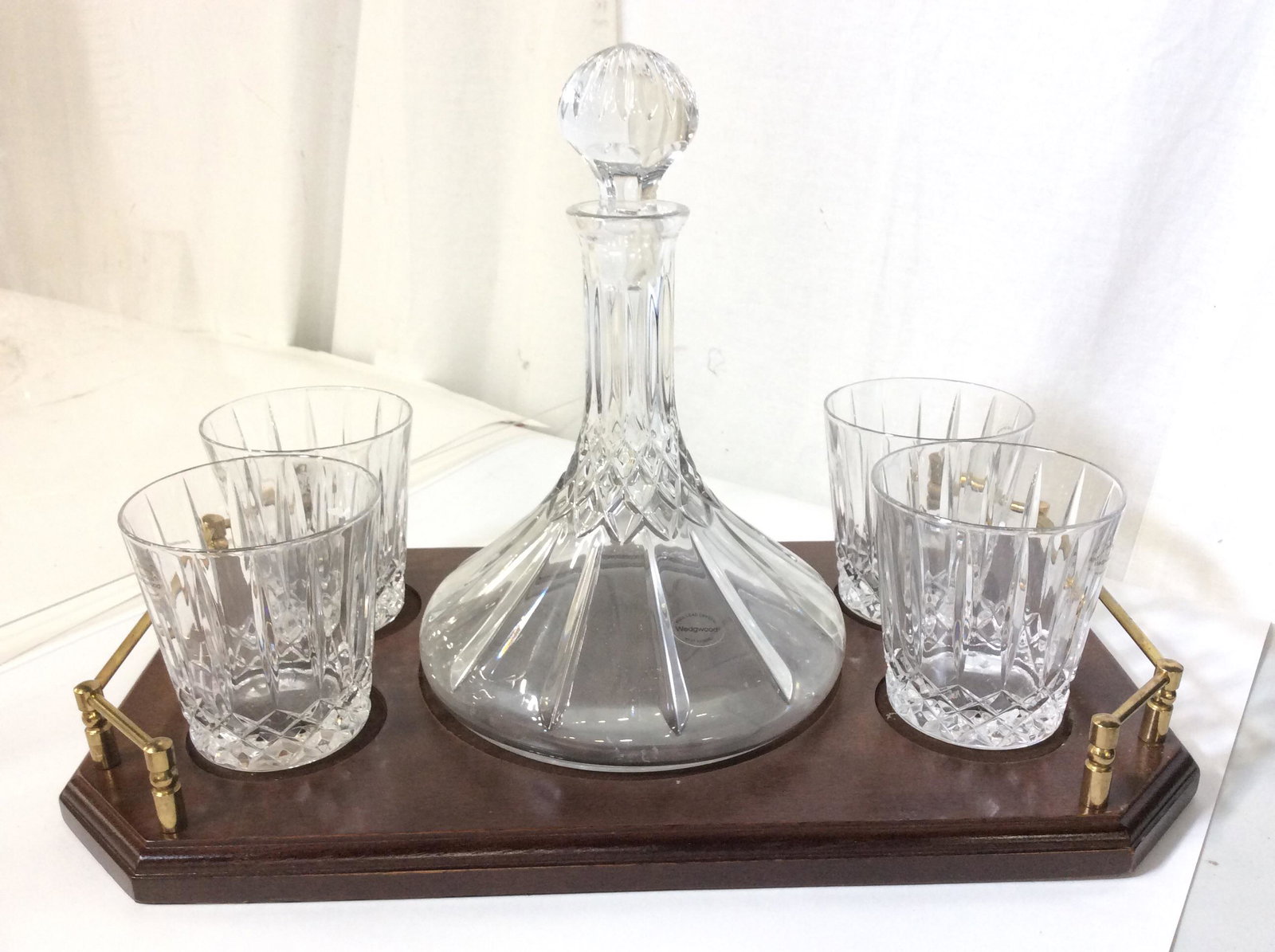 Vintage Wedgewood Crystal Decanter Bar Set: Lead crystal Decanter with stopper and 4 lead crystal tumblers on wood Carry Tray with brass handles. Sticker on Decanter reads Full Lead Crystal, West Germany, Wedgwood. All pcs with sticker, all pcs