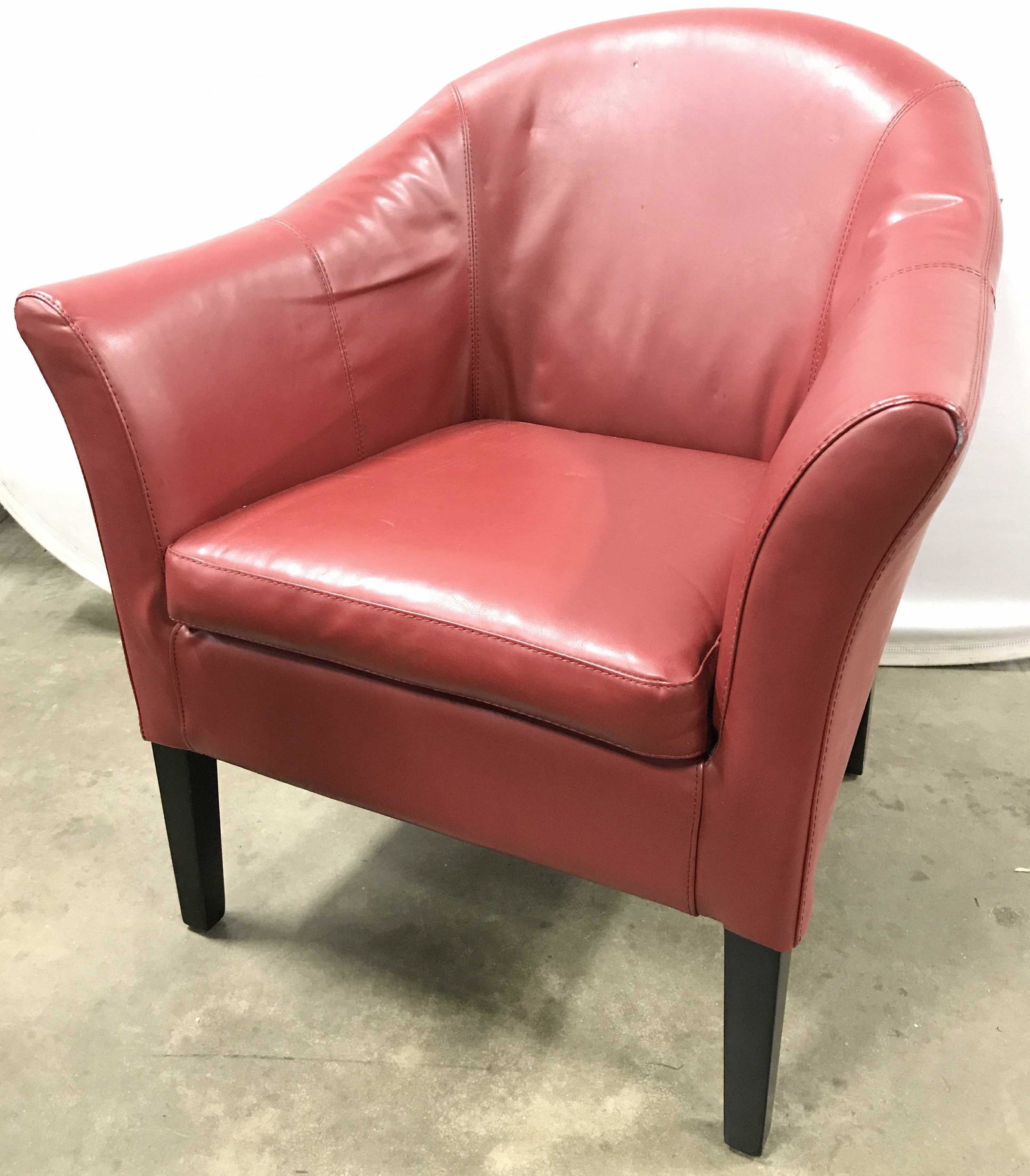MEIYI FURNITURE LTD Leather Armchair: Armchair is red toned. Piece is possibly genuine leather. Piece has 4 black toned wooden legs. Underside has tag which reads MEIYI FURNITURE LTD. Chair, armchair, leather armchair, red armchair, livin