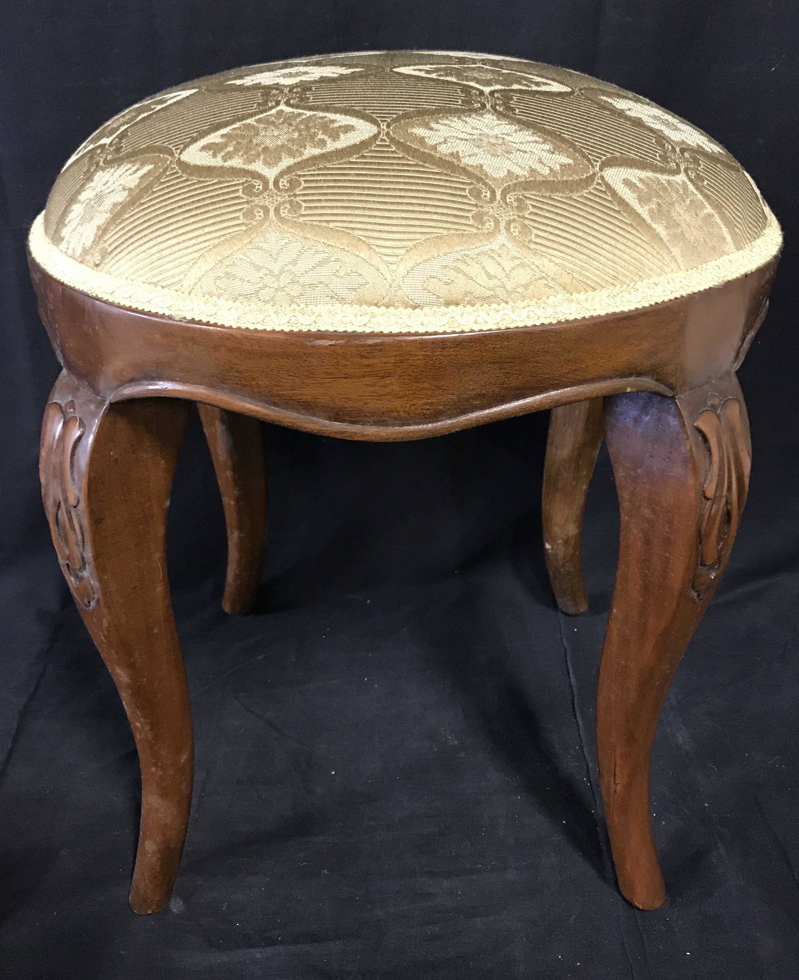 Upholstered Footstool: Possibly vintage upholstered stool or footstool, measures approx 18.5 inches H, 16 inches W. Braided ribbon trim connects the frame and upholstery. For stool, stool, ottoman, bedroom accessory, living