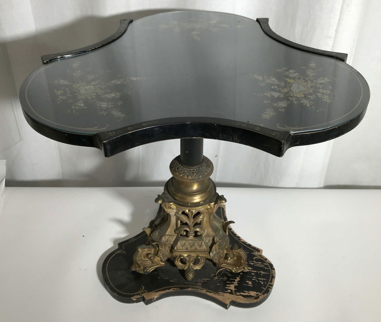 Vintage Hand Painted Side Table: Possibly antique side table, colored with gilt paint. Base is wood affixed to brass, includes a removable glass top, opalescent floral pattern decorated tabletop. Measures approx 19 inches H, and 20.7