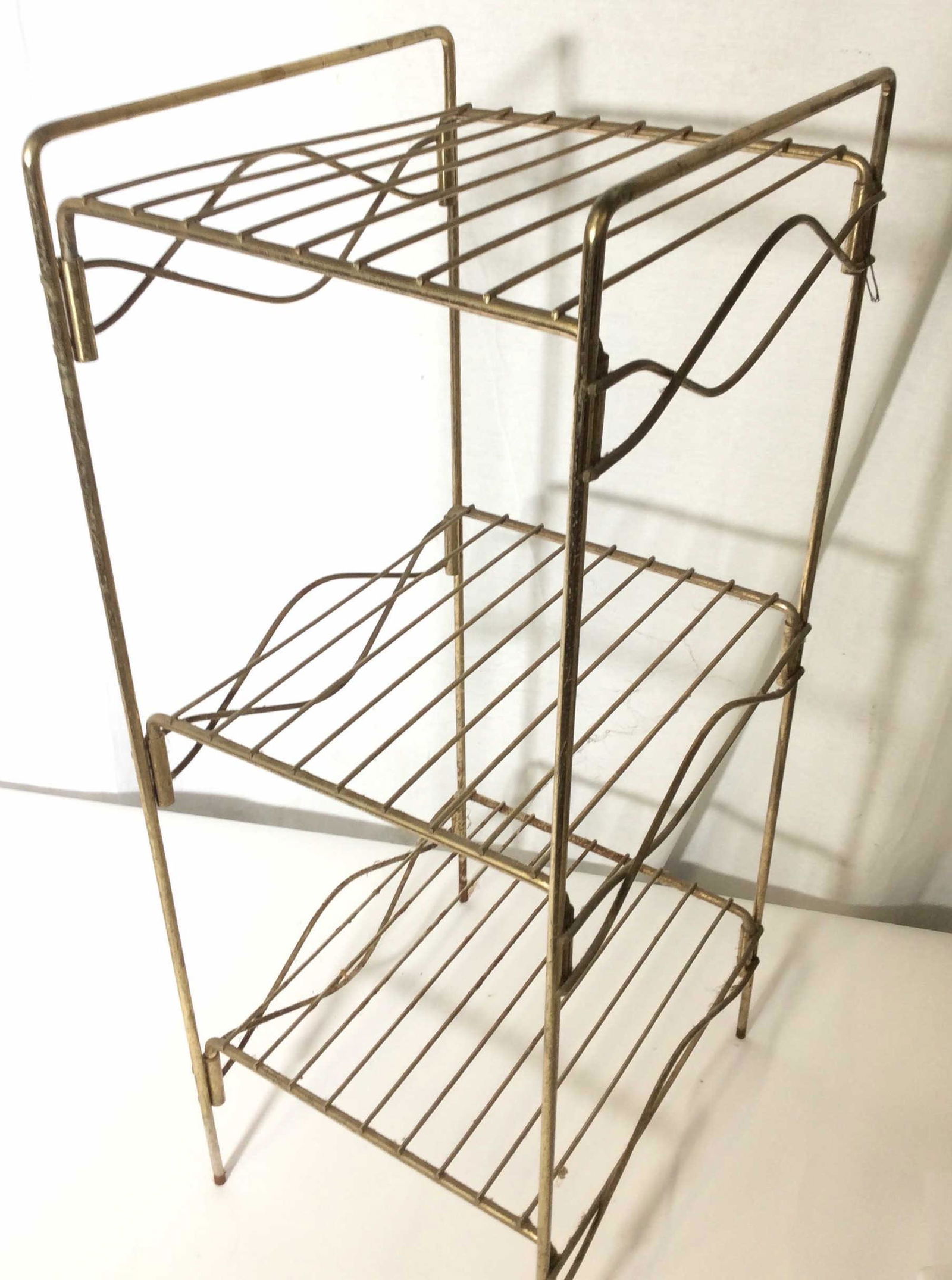 Brass Wire 3 Tier Standing Shelf: Vintage item, 3 shelves, Brass ( Plated) is tarnished, a little wobbly. Upcycle For Art or add new rubber feet and spray paint new color. 27 .25 in ht, 10 in width. Standing shelf, Vanity, Brass Vinta
