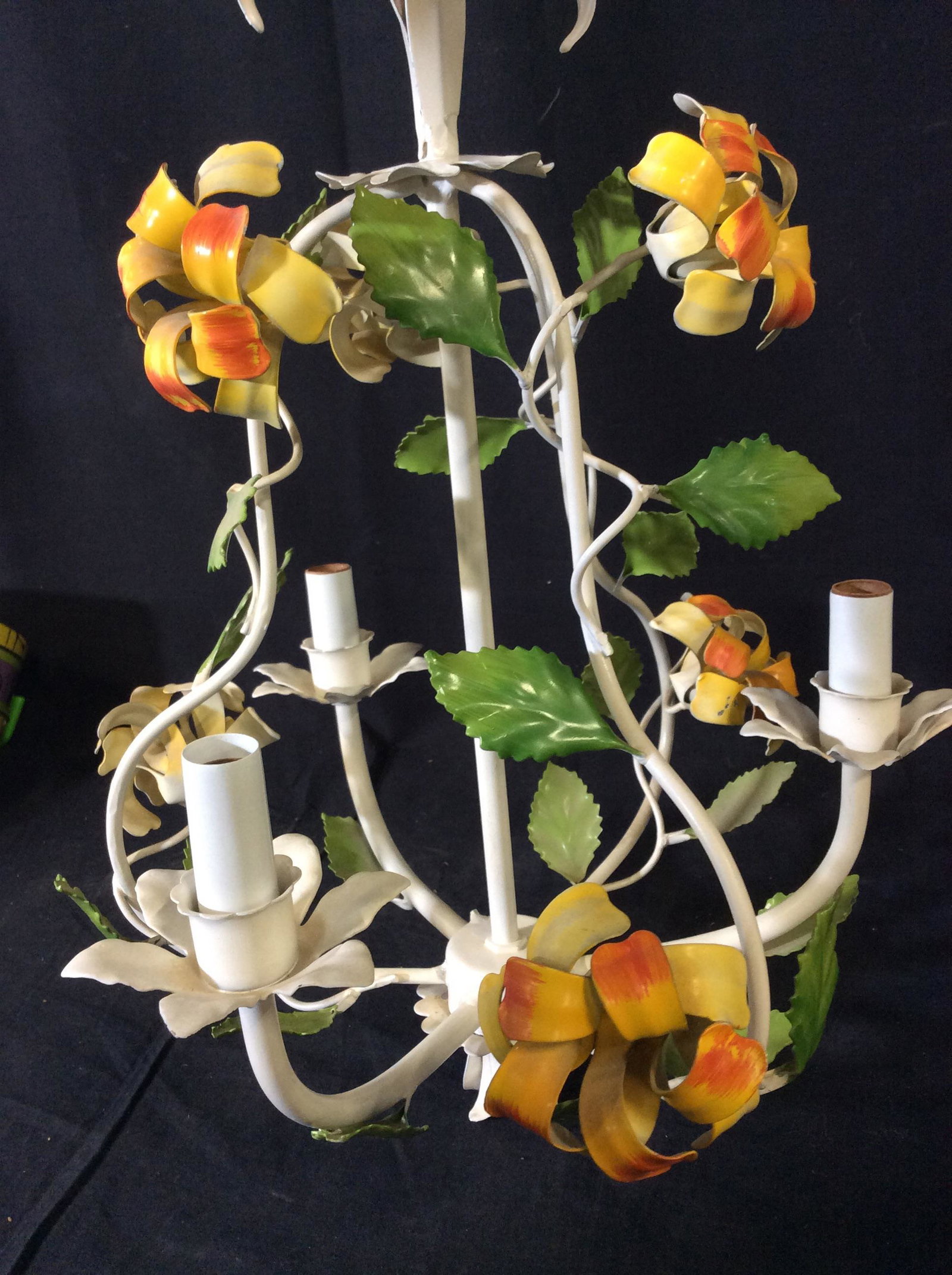 Vintage Enameled Flower 3 Arm Chandelier: White enamel, green leaves, yellow- orange florals. 3 Chandelier light bulbs. Ceiling fixture with hanging chain 9 in long. Chandelier dimensions 17.5 in long, 13 in. width. Up cycle, Vintage Ceiling 
