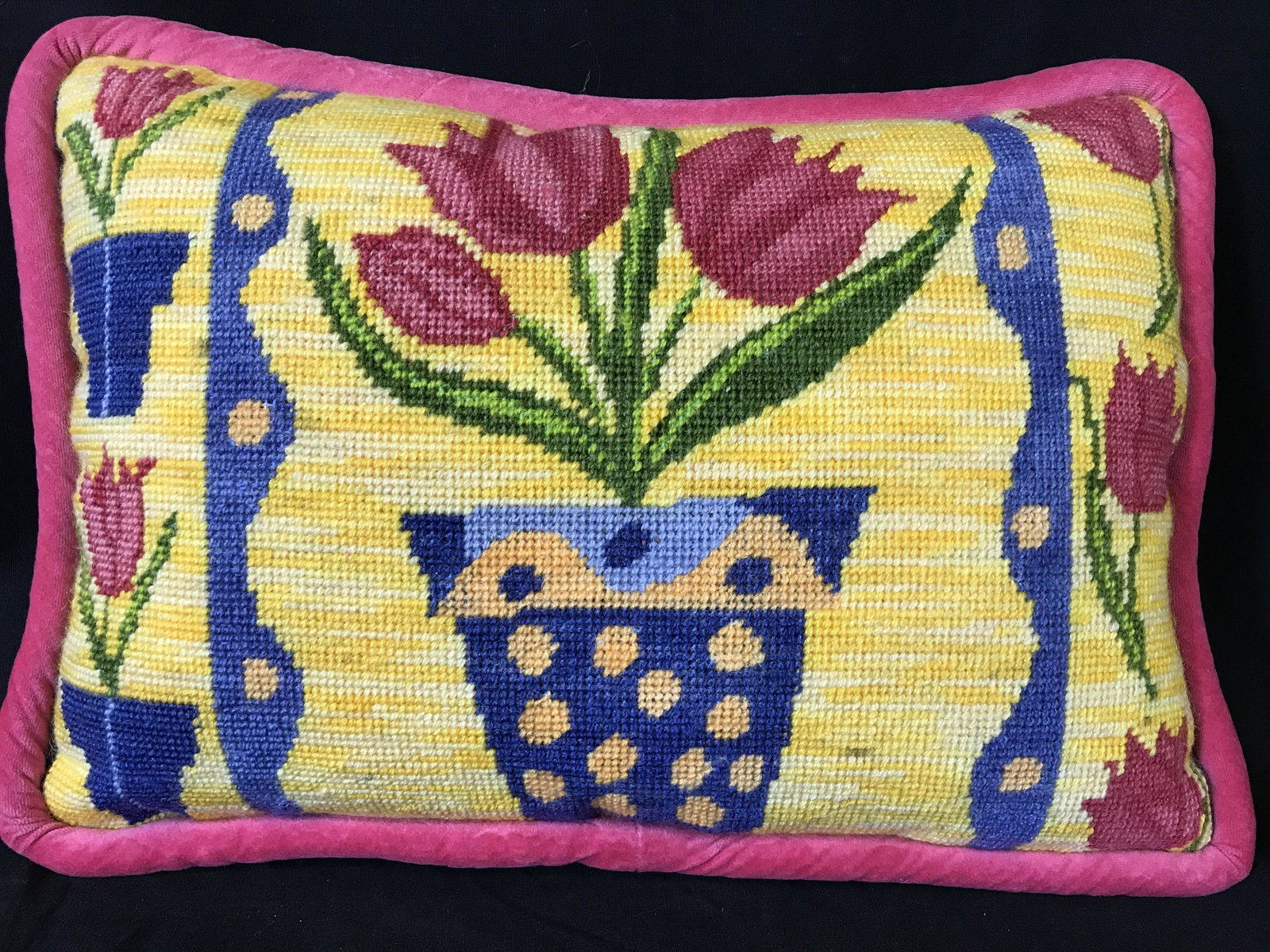 Needle Point Throw Pillow: Needle point throw pillow, depicts potted flowers. Back and welting of pillow is a fluorescent pink. Measures approx 16 inches H, and 11 inches W. Throw pillow, needlepoint, vintage pillows, vintage c