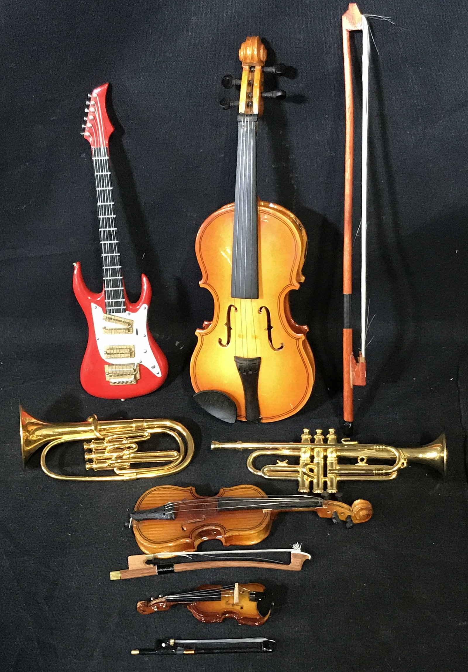 Collection of Miniature Instruments: Collection of 6 miniature instruments, instruments include an electric guitar cello trumpet tuba and two violins, all stringed instruments have bows, tallest object (the cello bow) measures 9 inches l