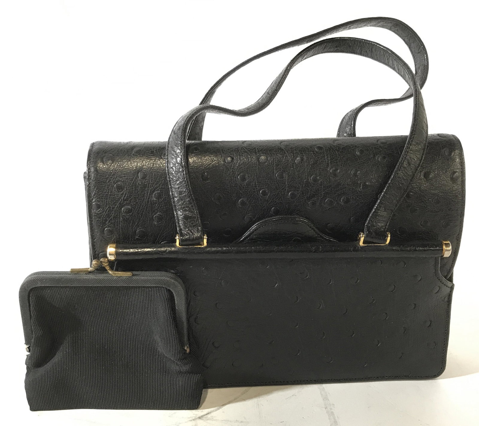 Black Faux Leather Hand Bag and Coin Purse: Black faux leather hand bag and accompanying coin purse, has a two straps, has two interior pockets one of which holds a hand mirror, a coin purse made of the same material as the interior of the purs
