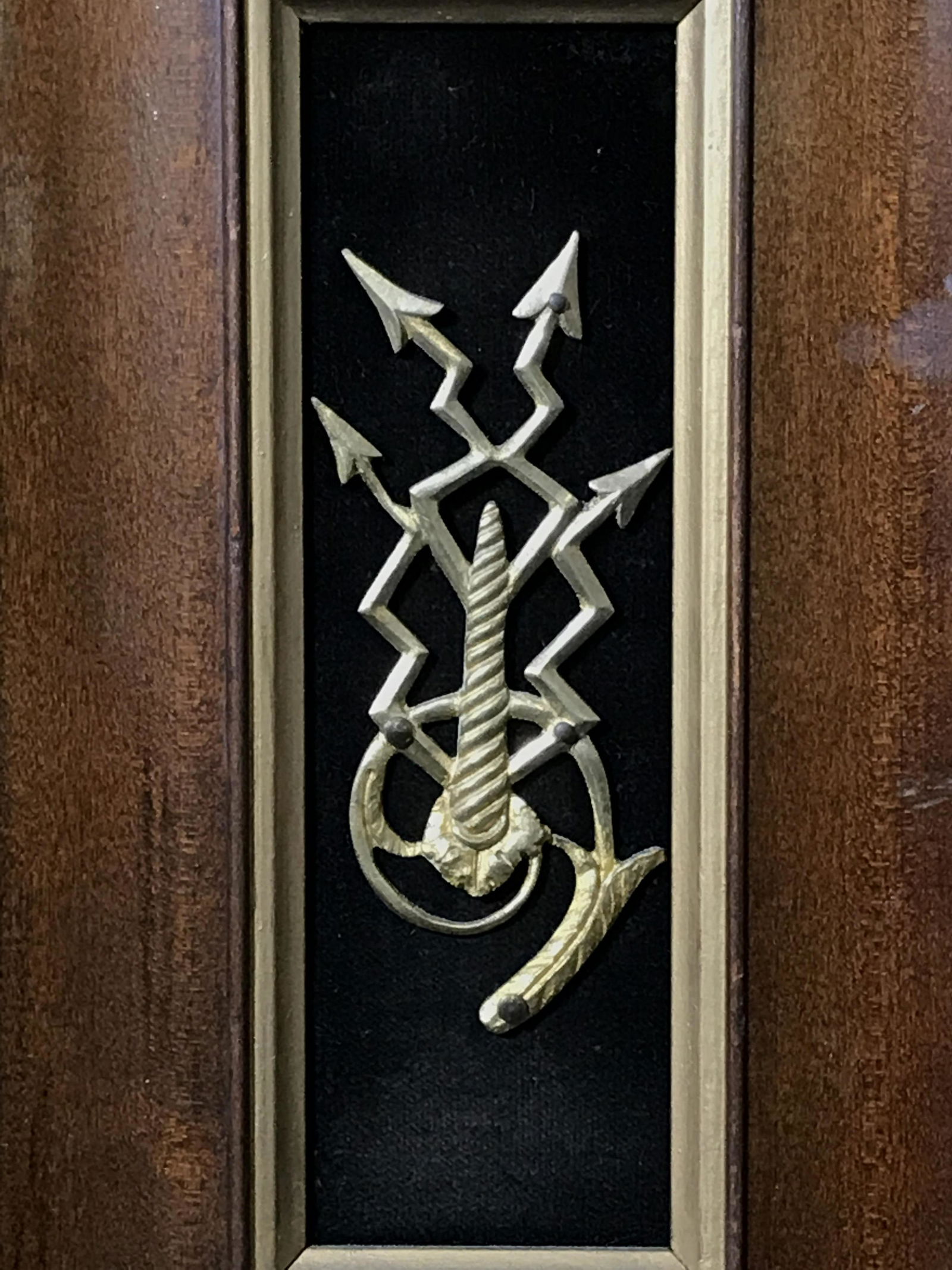 Framed Gold Toned Metal Crest: Framed gold toned metal crest, possibly gold plated, subject a metal crest nailed to a board, symbol appears to include the golden ration and possibly the arrows of chaos, wooden frame with gold paint