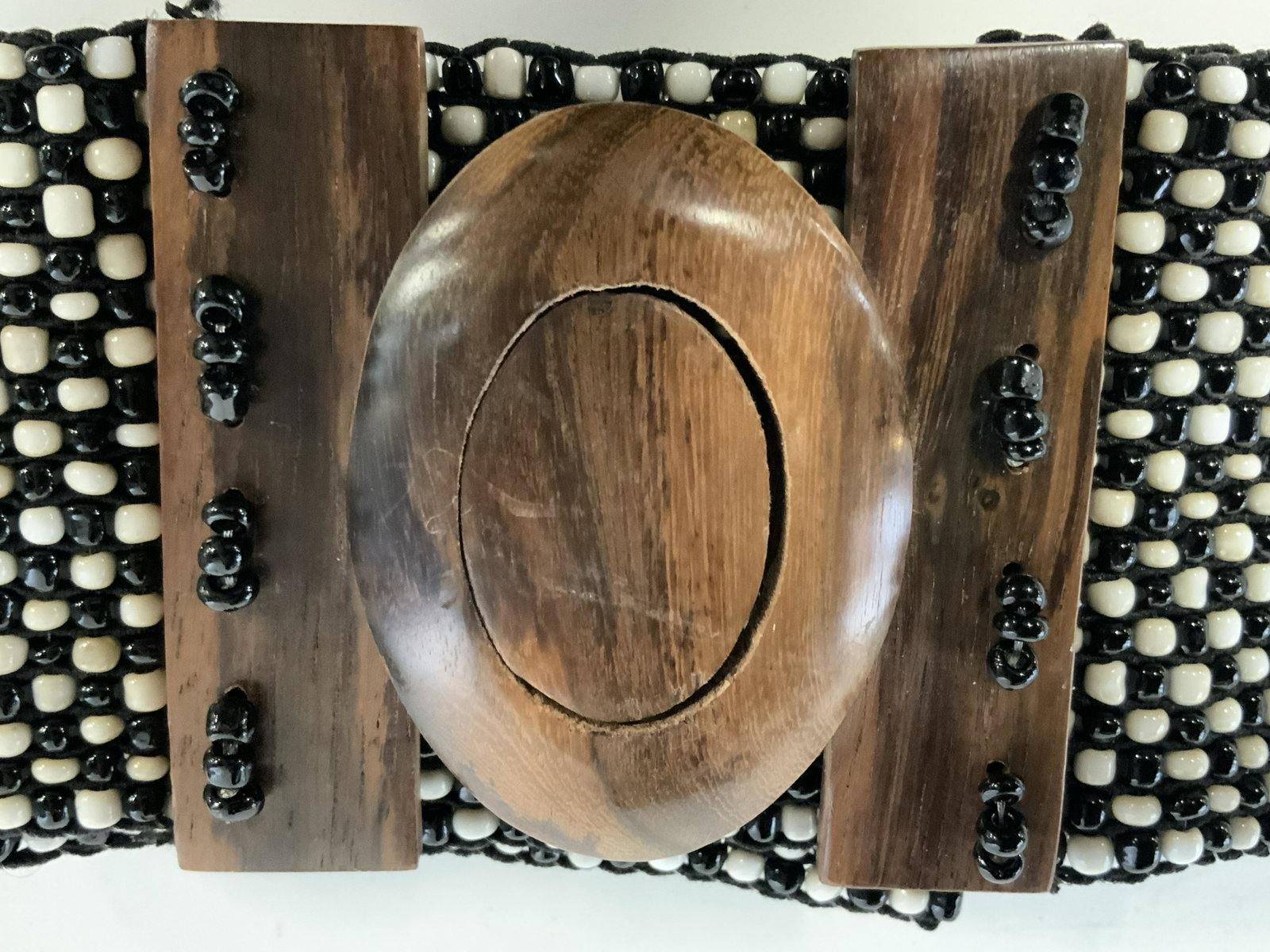 Vintage Beaded Belt: Vintage beaded belt with oval wooden closure, beads are set on elastic so that belt can be worn by many sizes and different areas of the mid section, beaded in black and white, there is an addition of
