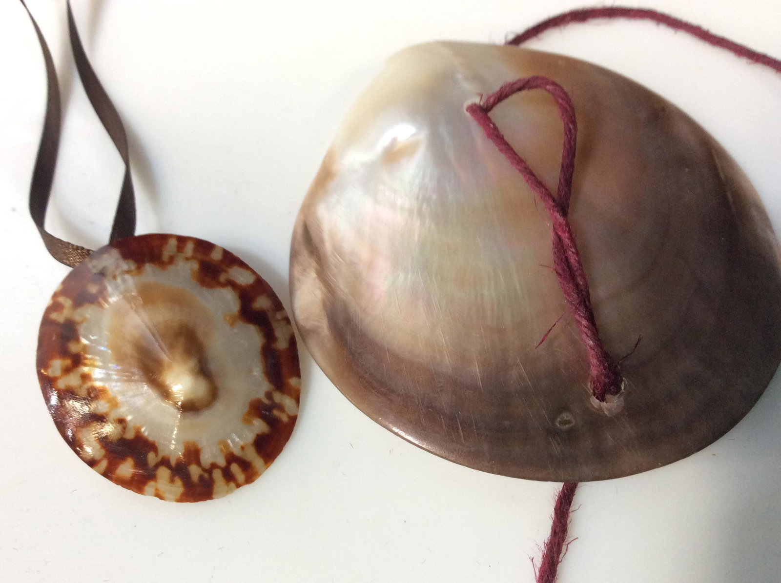 Lot 2 Lustrous Sea Shell Necklaces: Handmade Necklace on 24 in. brown ribbon, lobster claw clasp, Shell Pendant app 1.5 in. Large Mother of Pearl Shell with 2 drilled holes on raffia twine string. Twine over 5 ft. Seashells, Sea Shell H