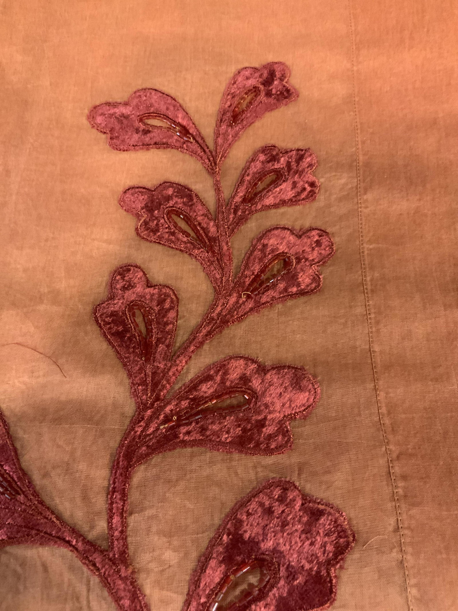 New in Packaging Set of Two Decorative Tablecloths: large table cloths in orange with a red felted velvet floral pattern and beading around the edge of the table where it hangs over the side, made of linen the this table cloth comes with its own fabric