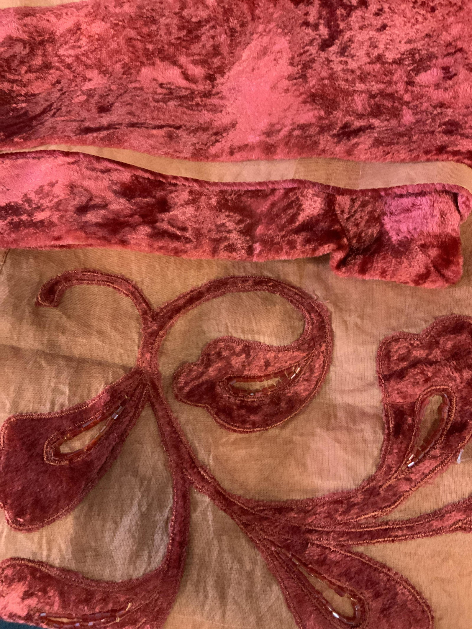 New in Packaging Set of Two Decorative Tablecloths: large table cloths in orange with a red felted velvet floral pattern and beading around the edge of the table where it hangs over the side, made of linen the this table cloth comes with its own fabric