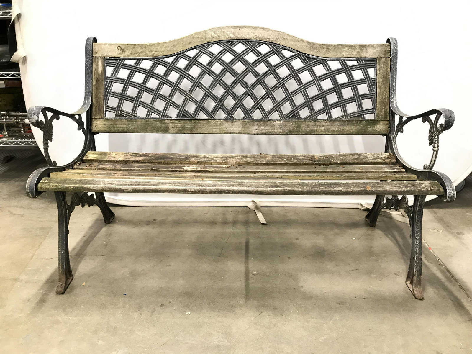 Vintage Outdoor Wood & Metal Bench: Bench is wooden. Piece is vintage. Bench has metal frame anD wooden seat & backrest. Piece measures approximately 51 inches long 34 inches tall 25 inches deep. Sides of becnhc have floral vine and lea