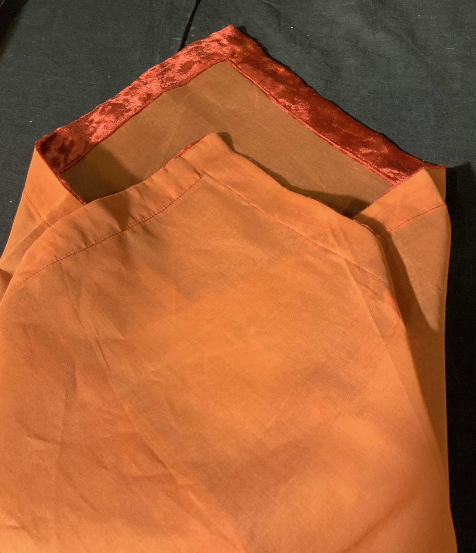 New in Packaging Set of 6 Decorative Napkins: Set of 6 napkins in sheer burnt orange with red velvet trim, napkins match previous lot of orange tablecloths, velvet on the table clothes, as if part of a set, bright and vibrant color, felted velvet