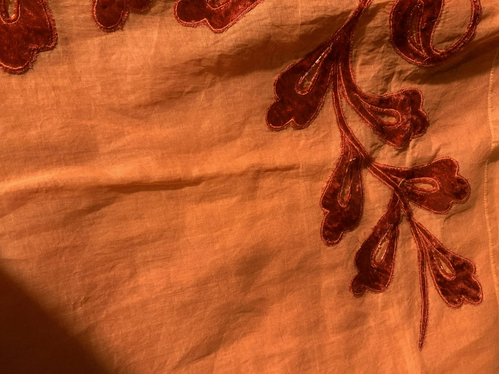 New Still in Packaging Set of 2 Tablecloth: large table cloths in orange with a red felted velvet floral pattern and beading around the edge of where it hangs over the side, made of composite fabrics, this table cloth comes with its own sheer f