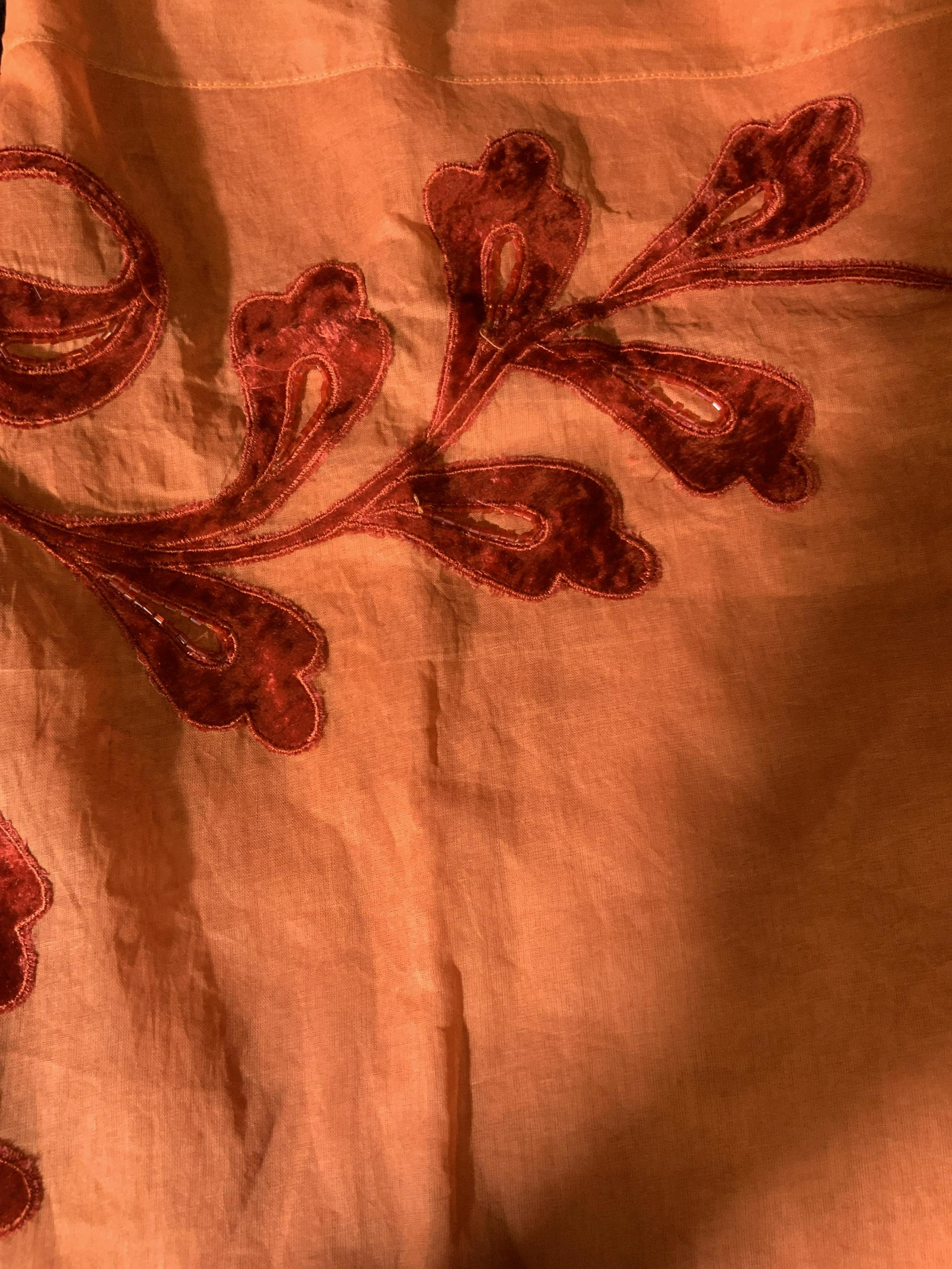 New Still in Packaging Set of Two Tablecloths: large table cloths in orange with a red felted velvet floral pattern and beading around the edge of the table where it hangs over the side, made of linen the this table cloth comes with its own fabric